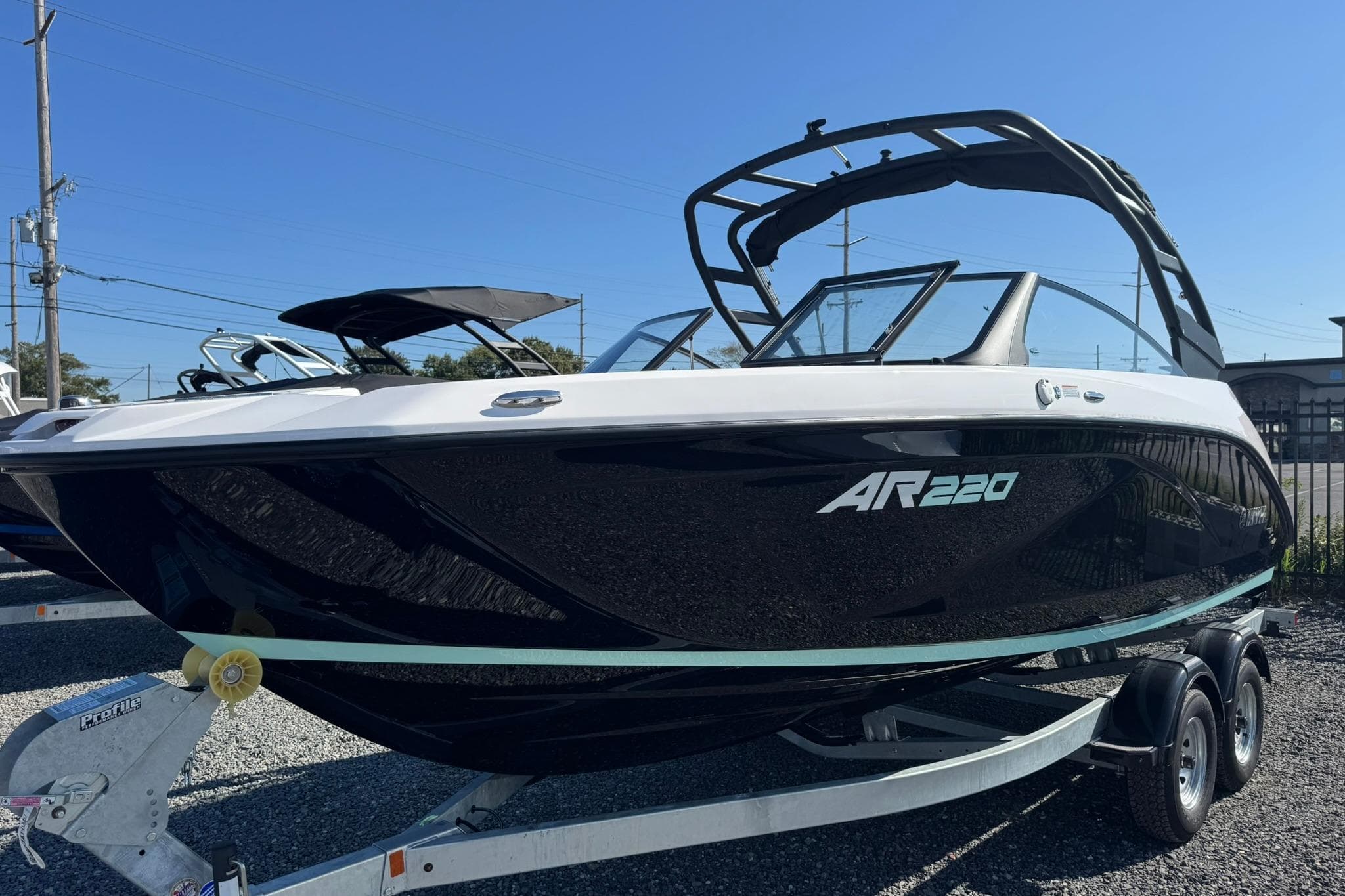 2026 Yamaha Boats AR220 on trailer, sleek black and white design, outdoor display.