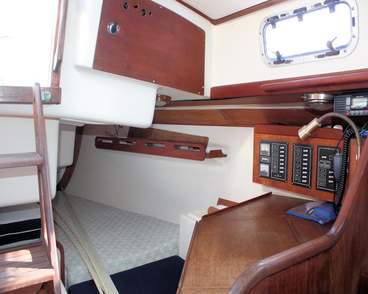 Interior of 1988 Tartan 34-2 Scheel Keel sailboat with wood paneling and navigation equipment.