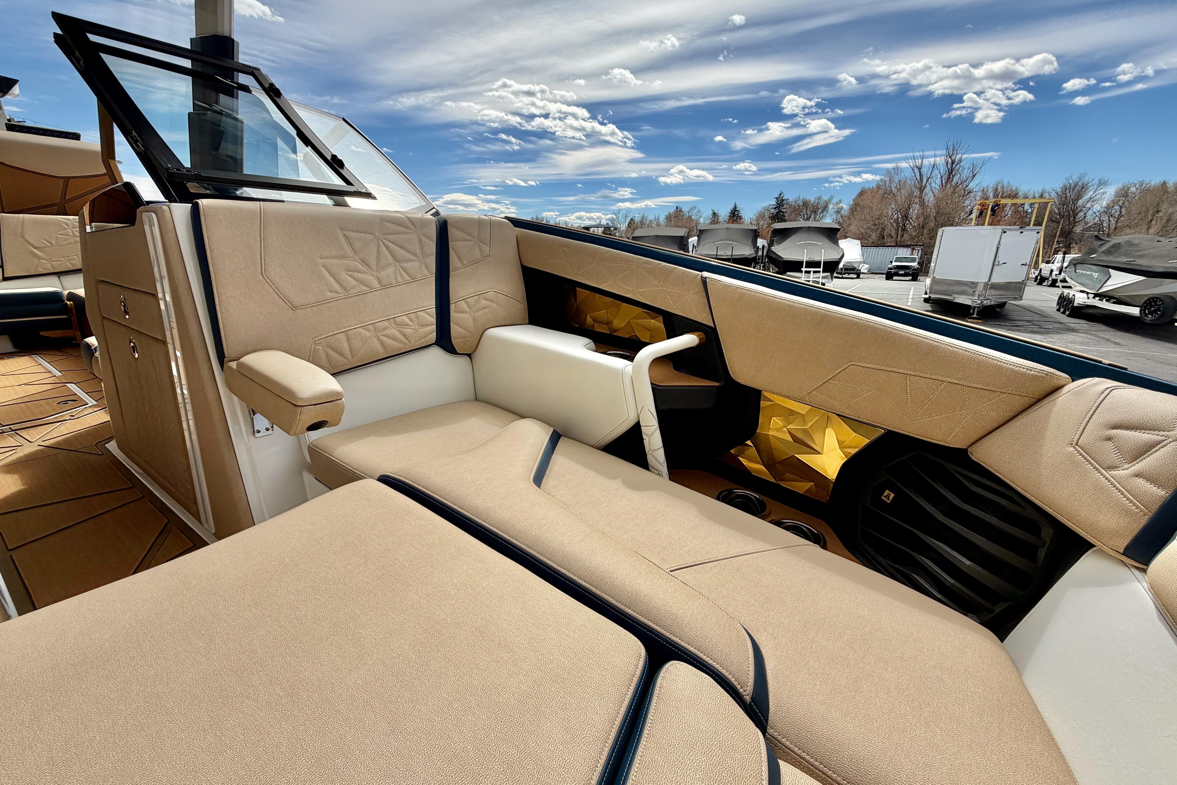 Luxurious interior of 2025 Nautique Super Air Nautique G25 Paragon boat under a clear sky.