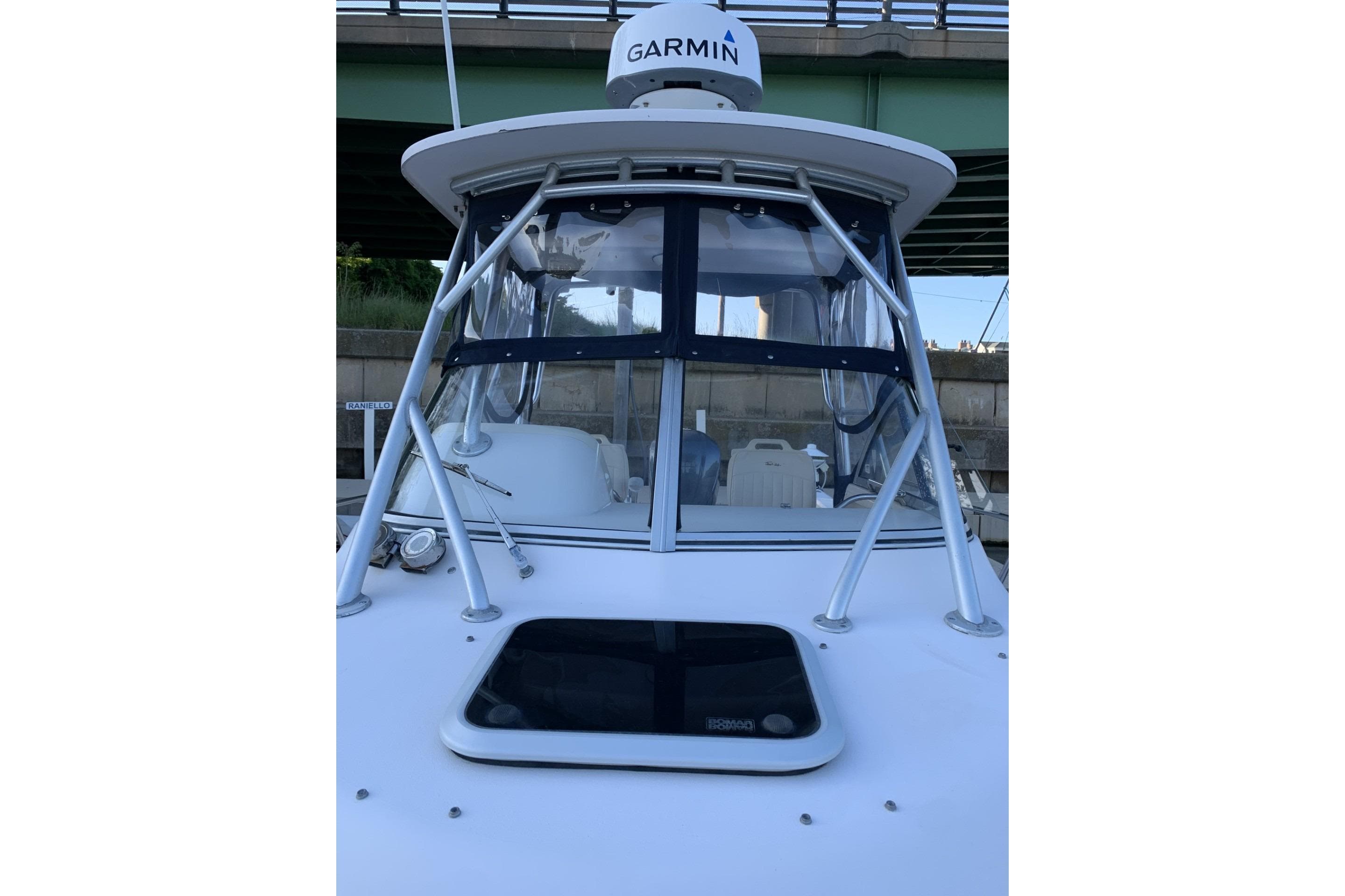 2001 Grady-White Seafarer 226 boat with Garmin radar, docked under a bridge.