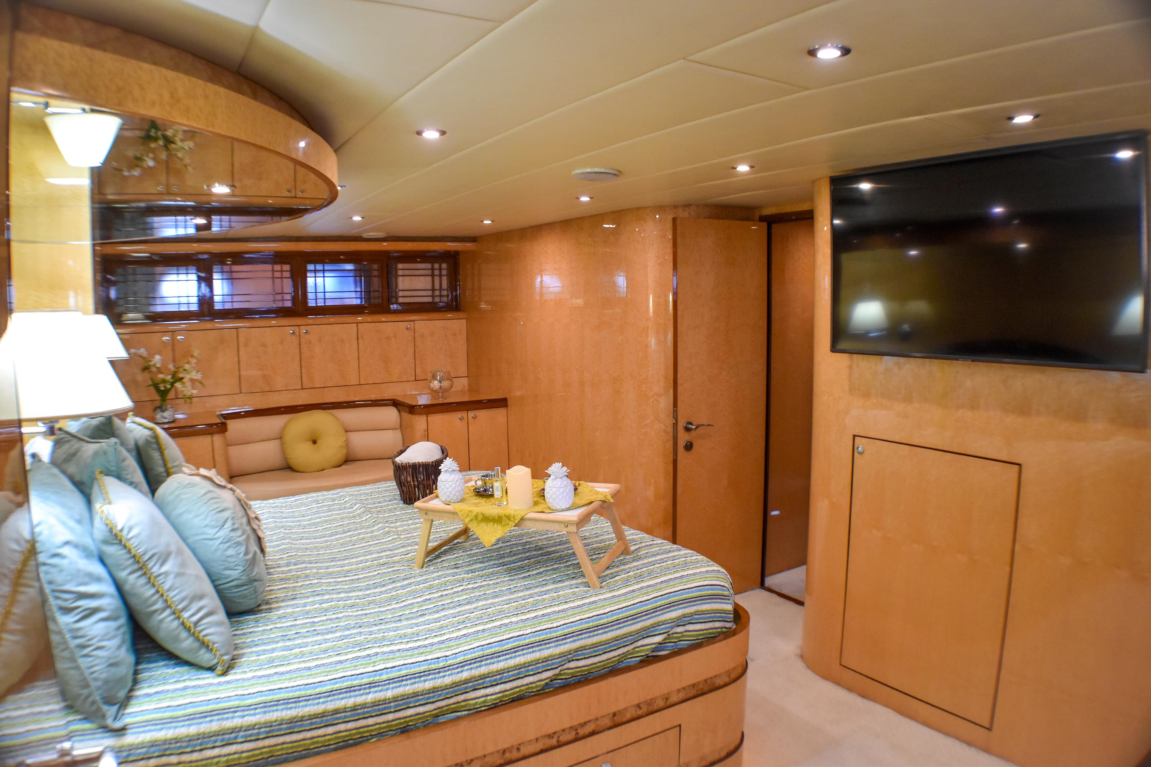 Luxurious 2006 Johnson Country Kitchen yacht bedroom with modern decor and large TV.