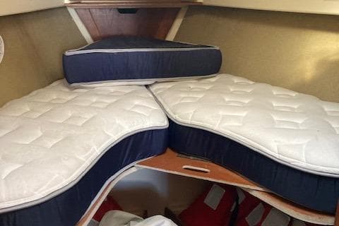 V-berth with custom mattresses in a 1985 Pearson 36-2 sailboat cabin.