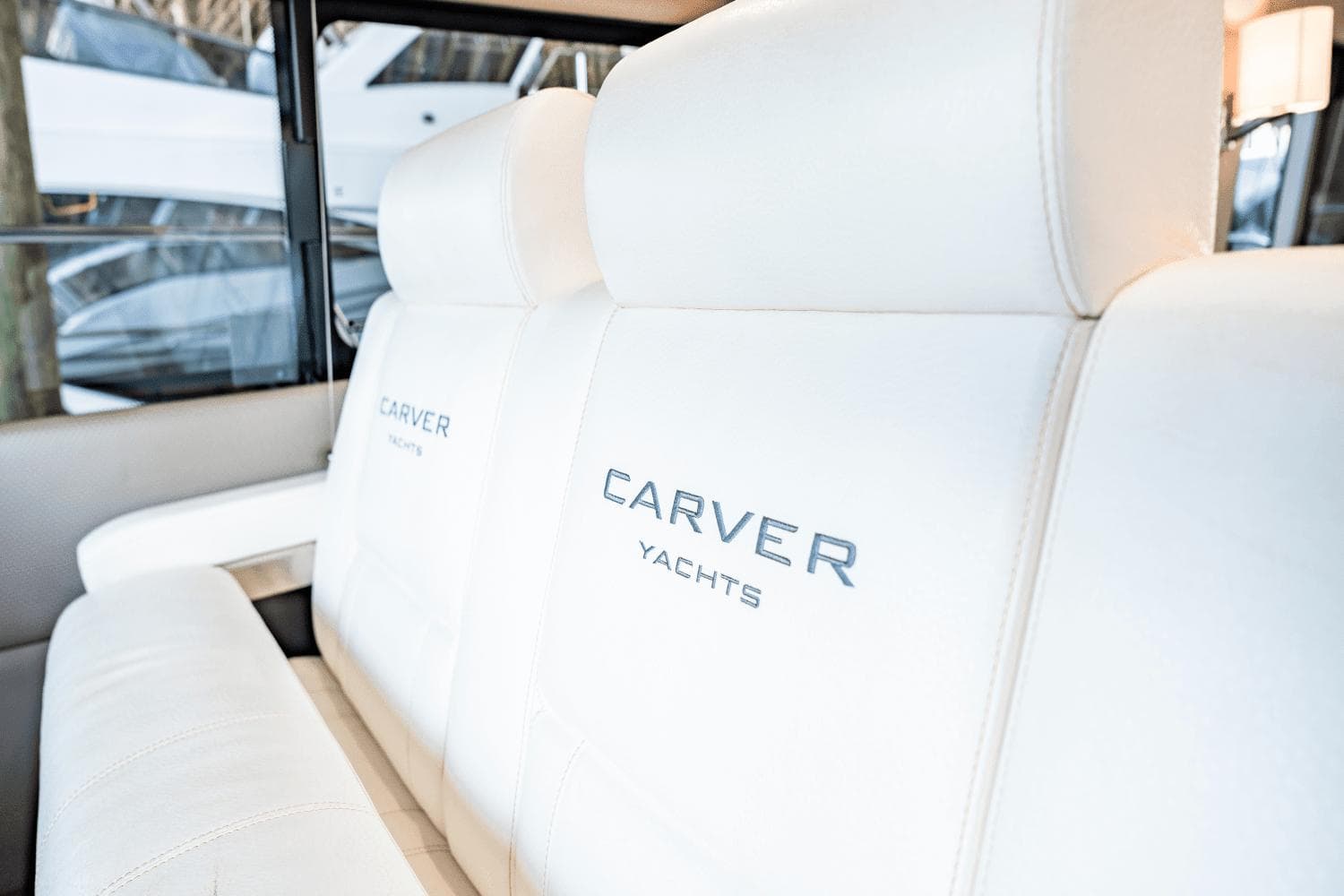 Luxurious white seating on 2017 Carver 52 Command Bridge yacht interior.