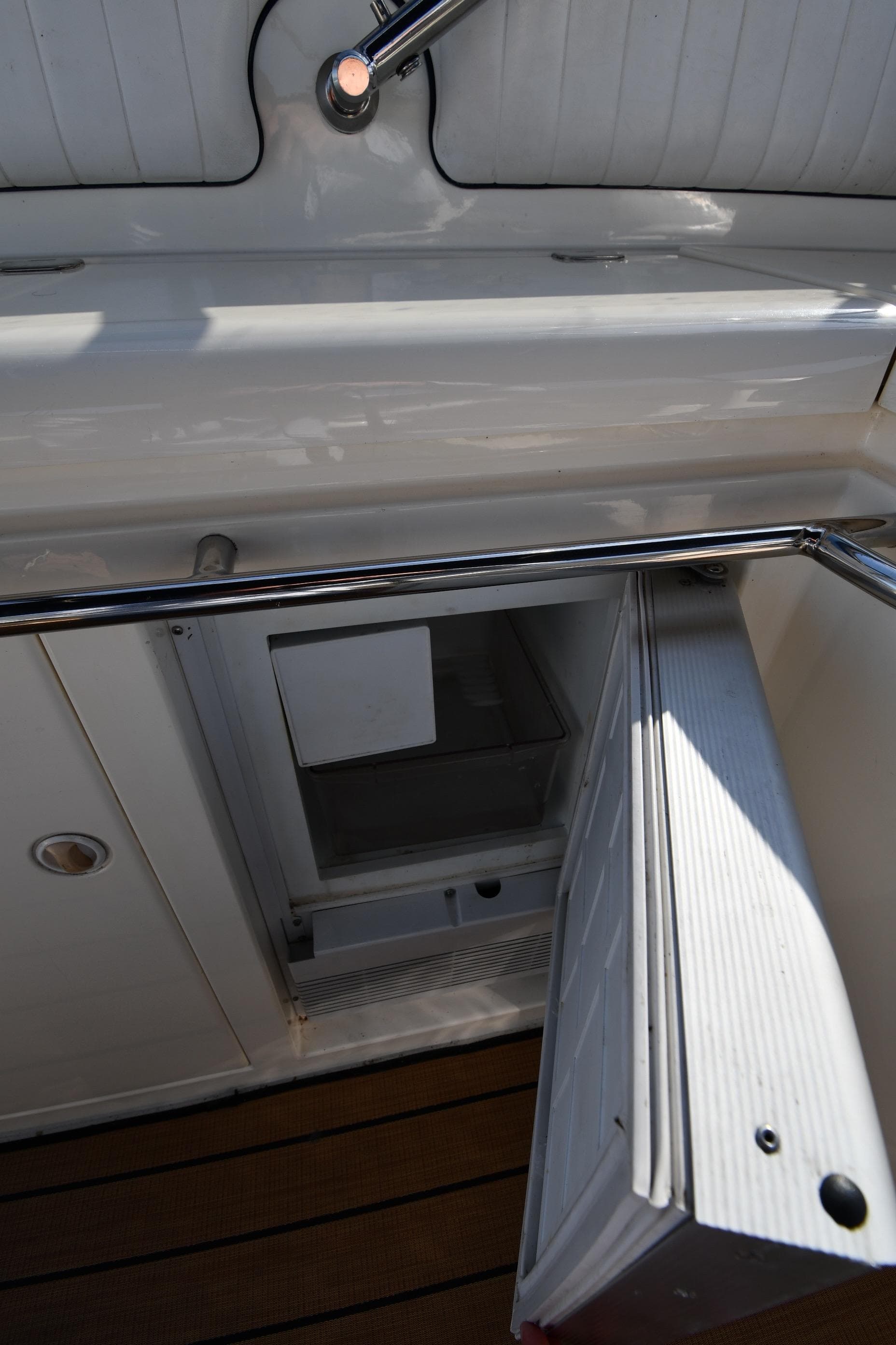 Open refrigerator on 1996 Sunseeker 55 CAMARGUE yacht, showcasing interior storage space.