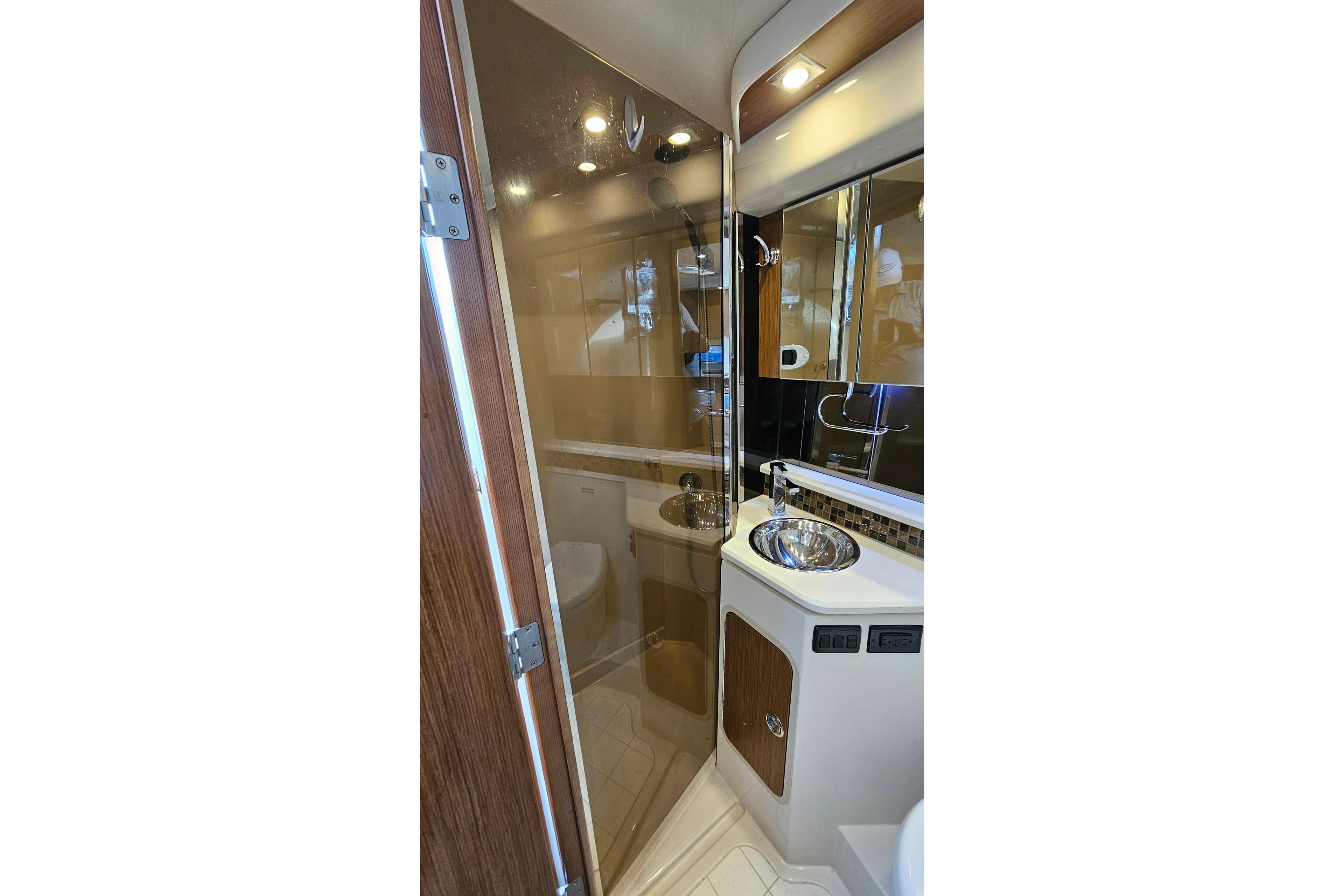 Luxurious bathroom interior of 2017 Cruisers Yachts 380 Express with modern fixtures.