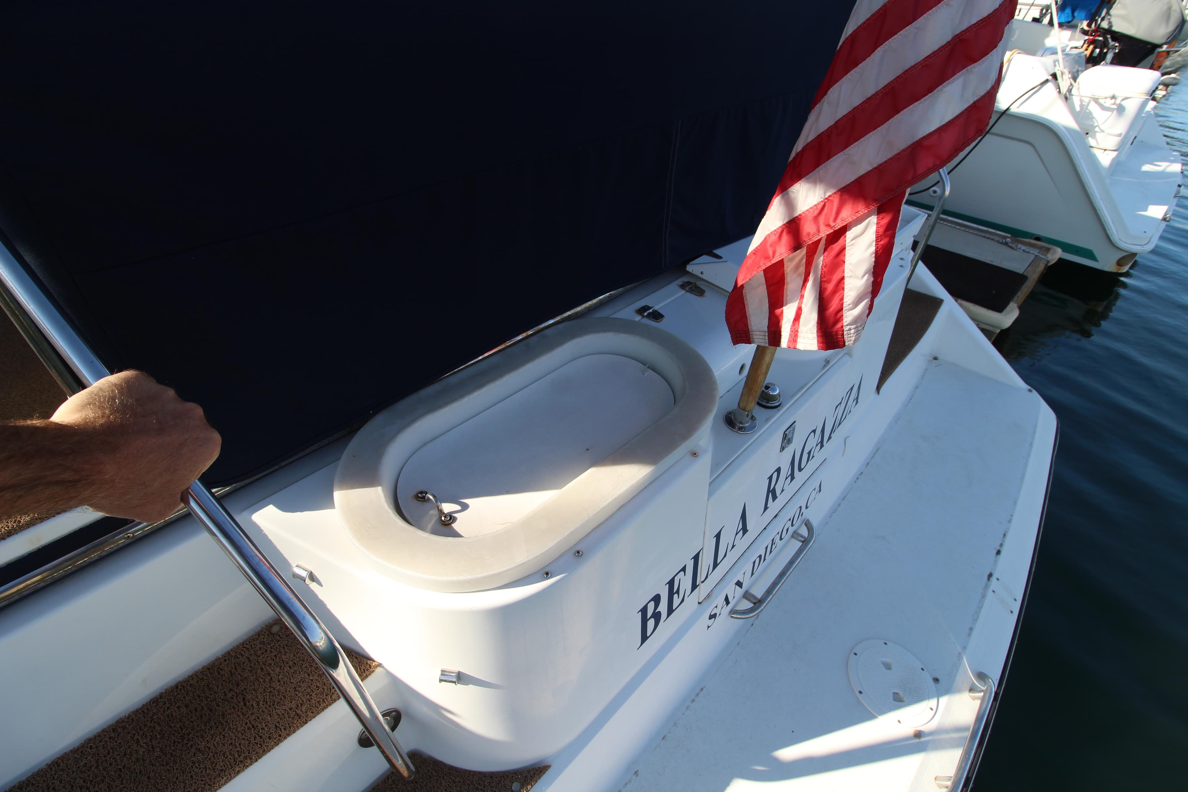 1990 Carver 3467 Santego boat with American flag and "Bella Ricci" name on deck.