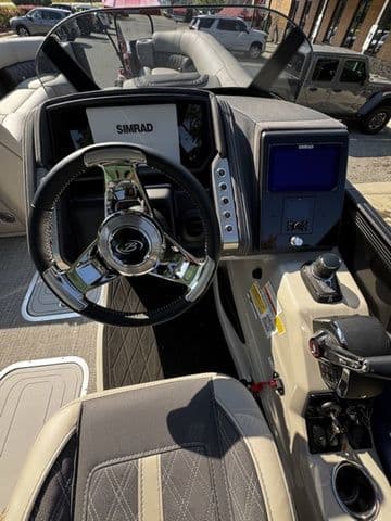2025 Barletta Lusso L25MAT boat dashboard with steering wheel and navigation system.