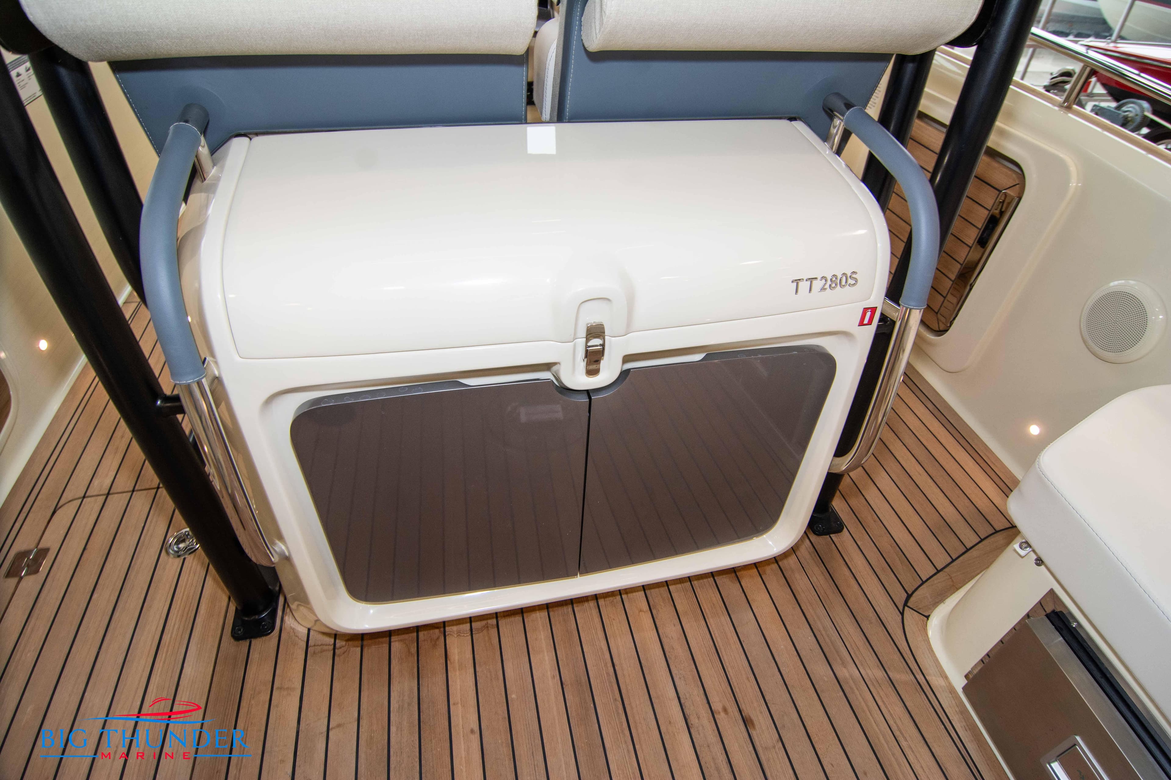 Invictus TT280S 2024 boat interior with wooden deck and storage compartment.