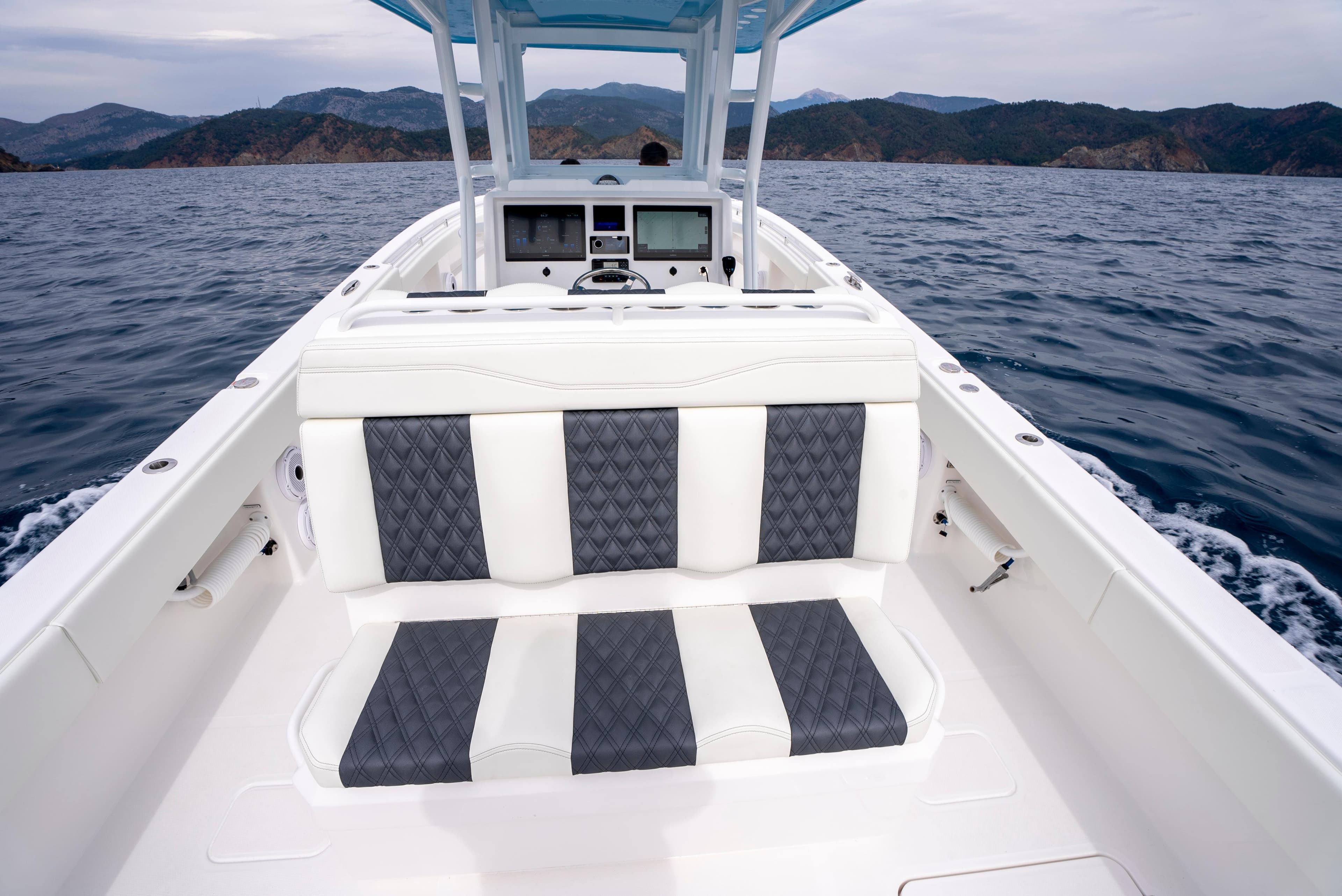 2024 Invincible 33 boat interior with striped seating, navigating open waters.
