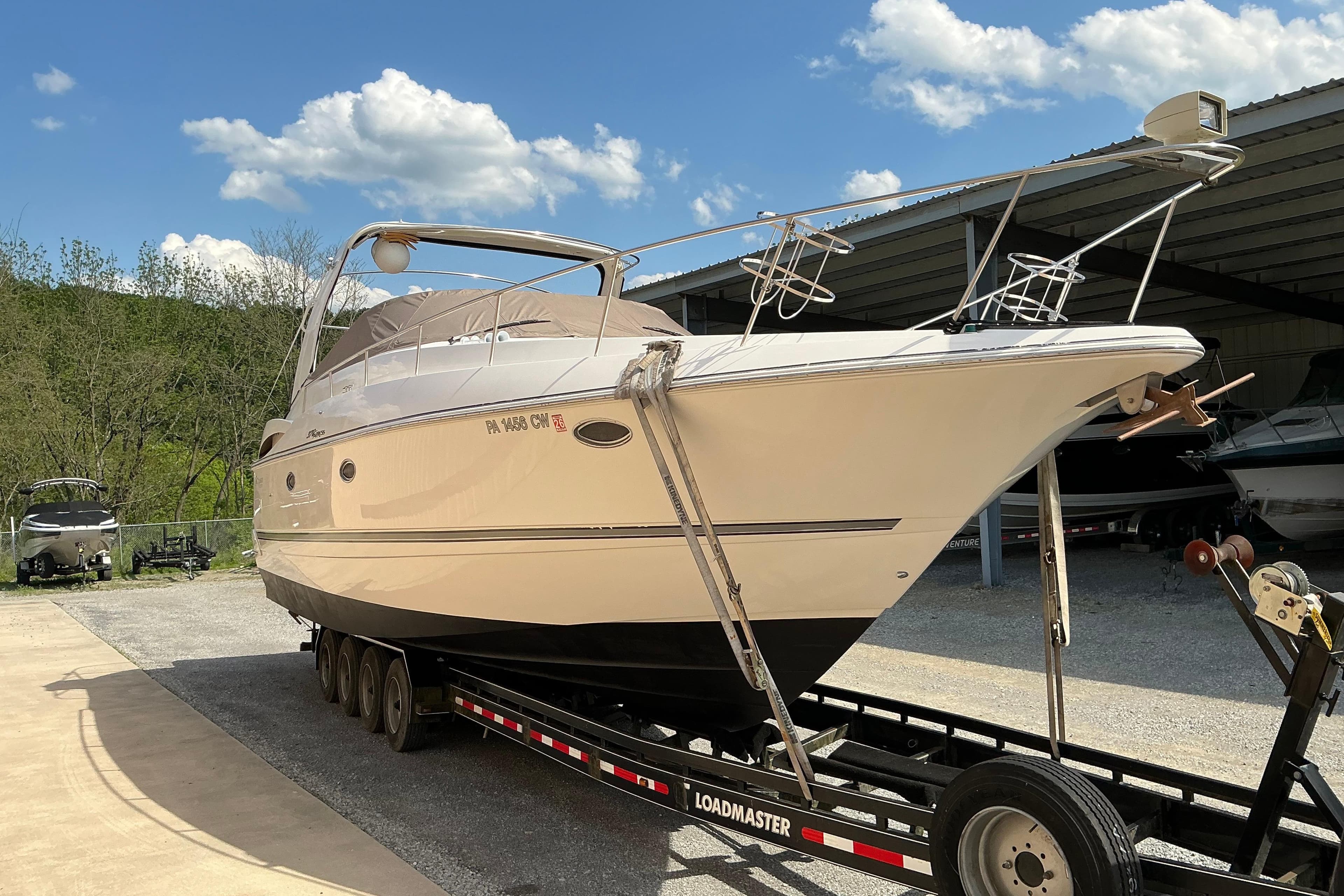 2005 Cruisers Yachts 370 Express on trailer under clear blue sky.