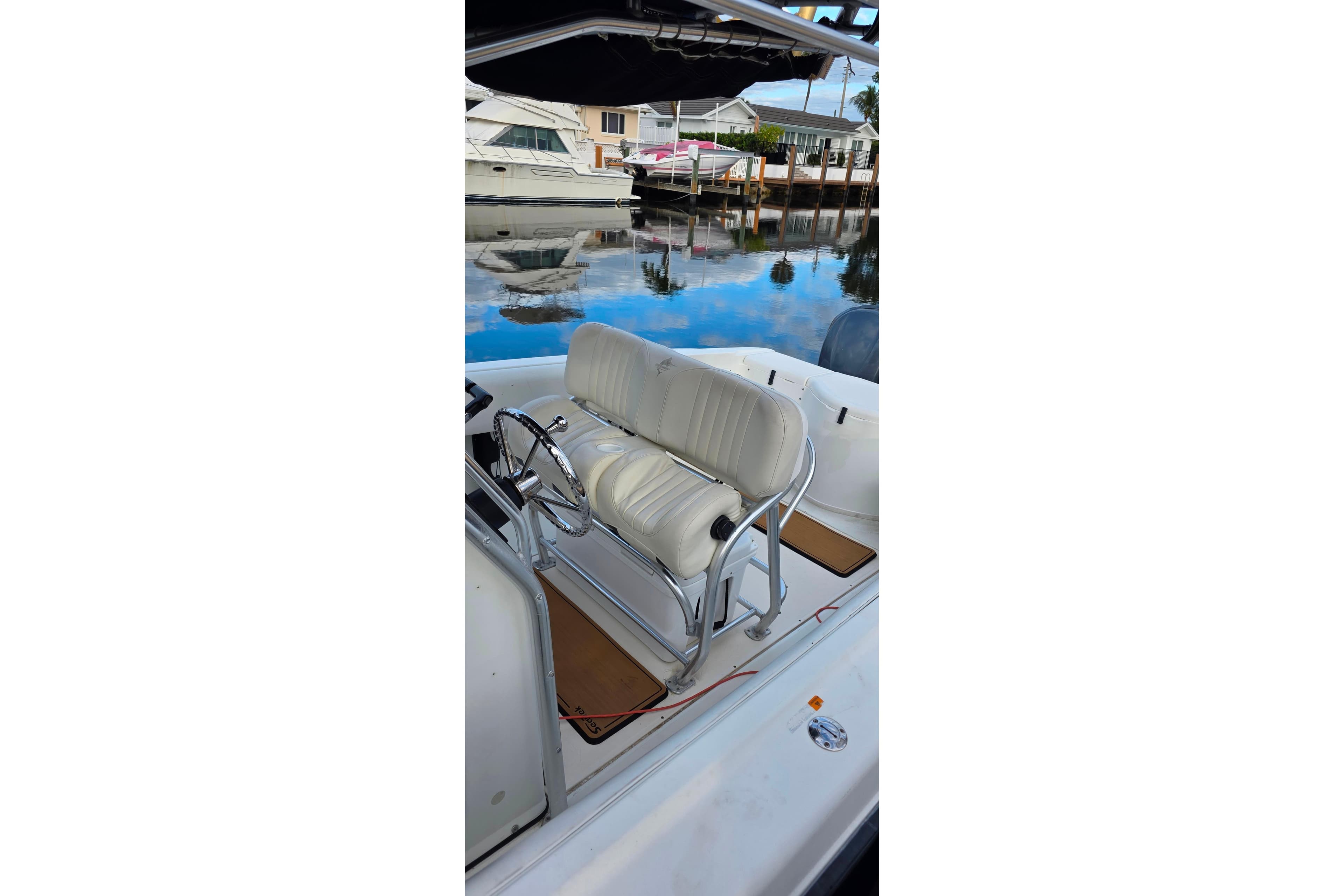 1999 Hydra-Sports 3000 CC boat interior with white seating and steering wheel.