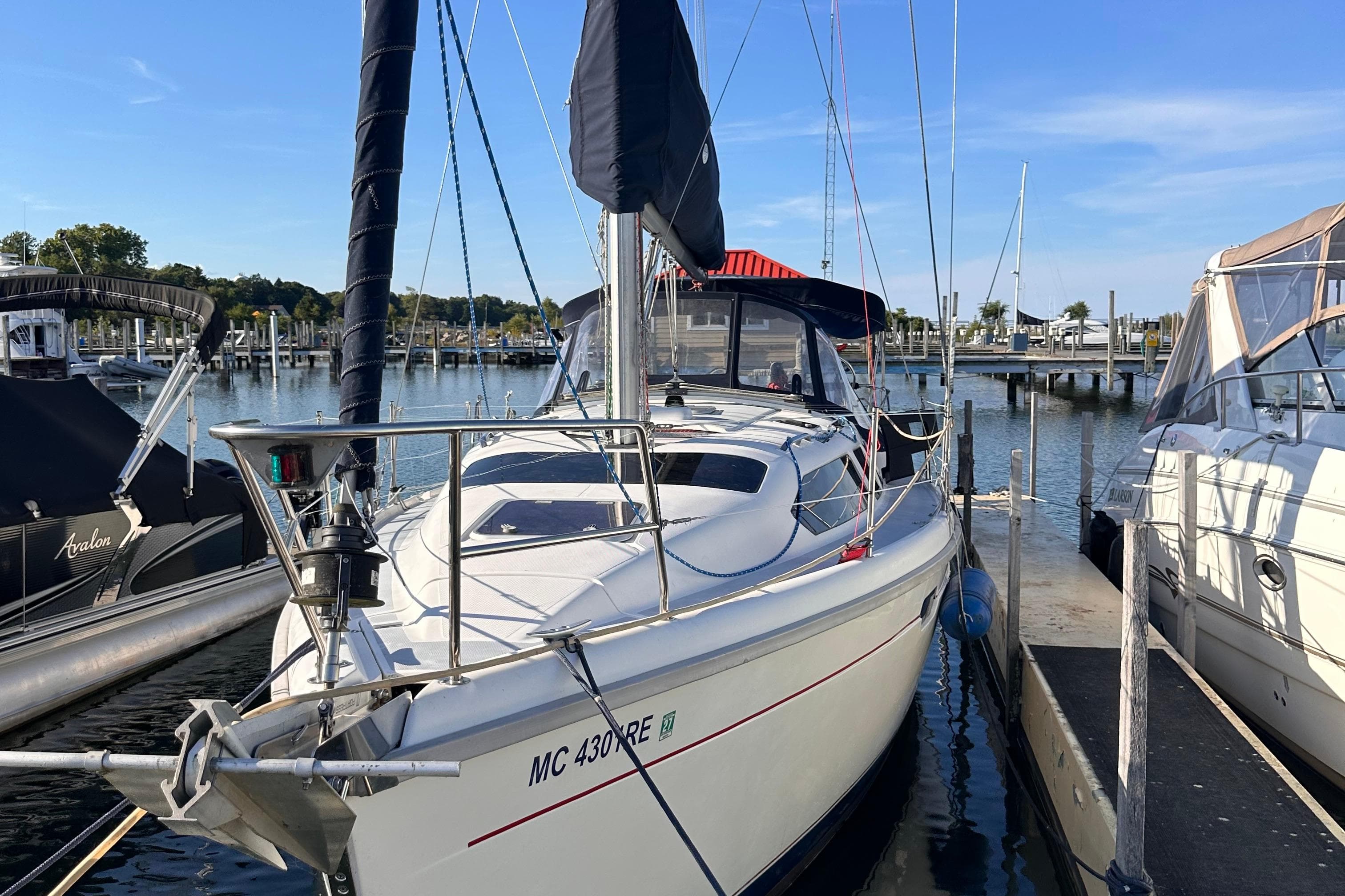 1997 Hunter 336 sailboat docked at a marina on a sunny day.