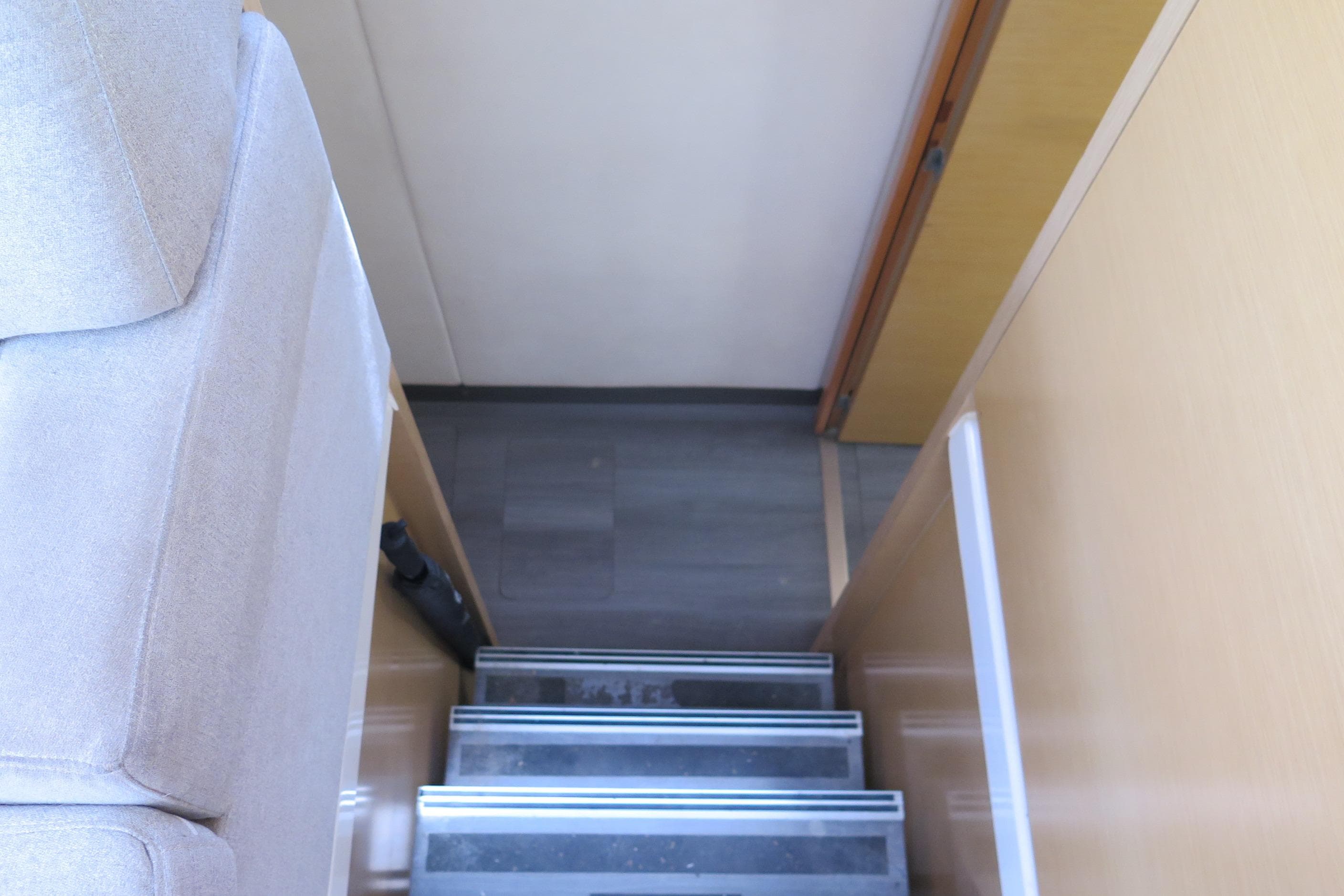 Interior stairs of 2013 Fountaine Pajot Helia 44 catamaran, featuring modern design and wood finish.