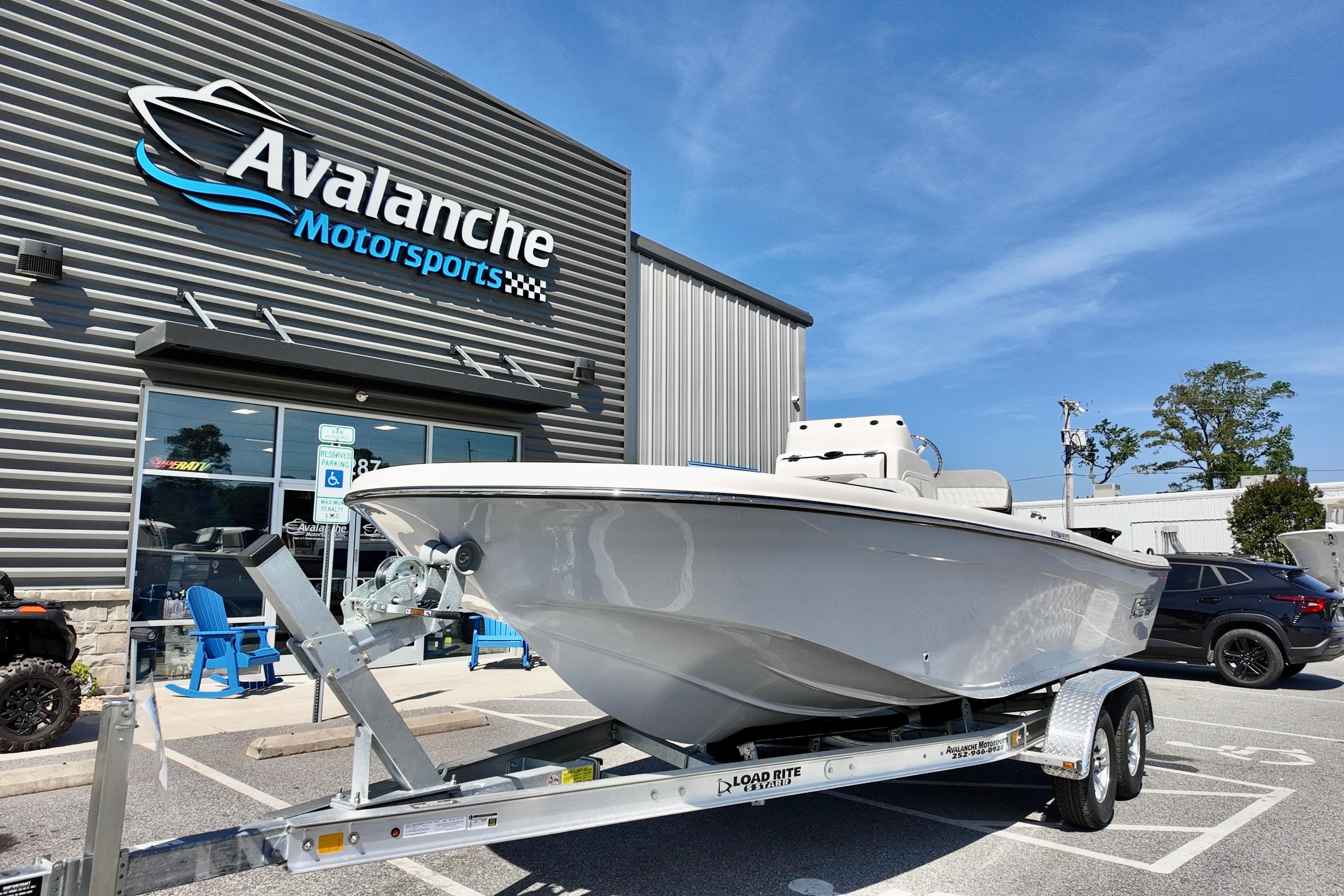 2026 Carolina Skiff 21 Ultra Elite boat on trailer at Avalanche Motorsports dealership.