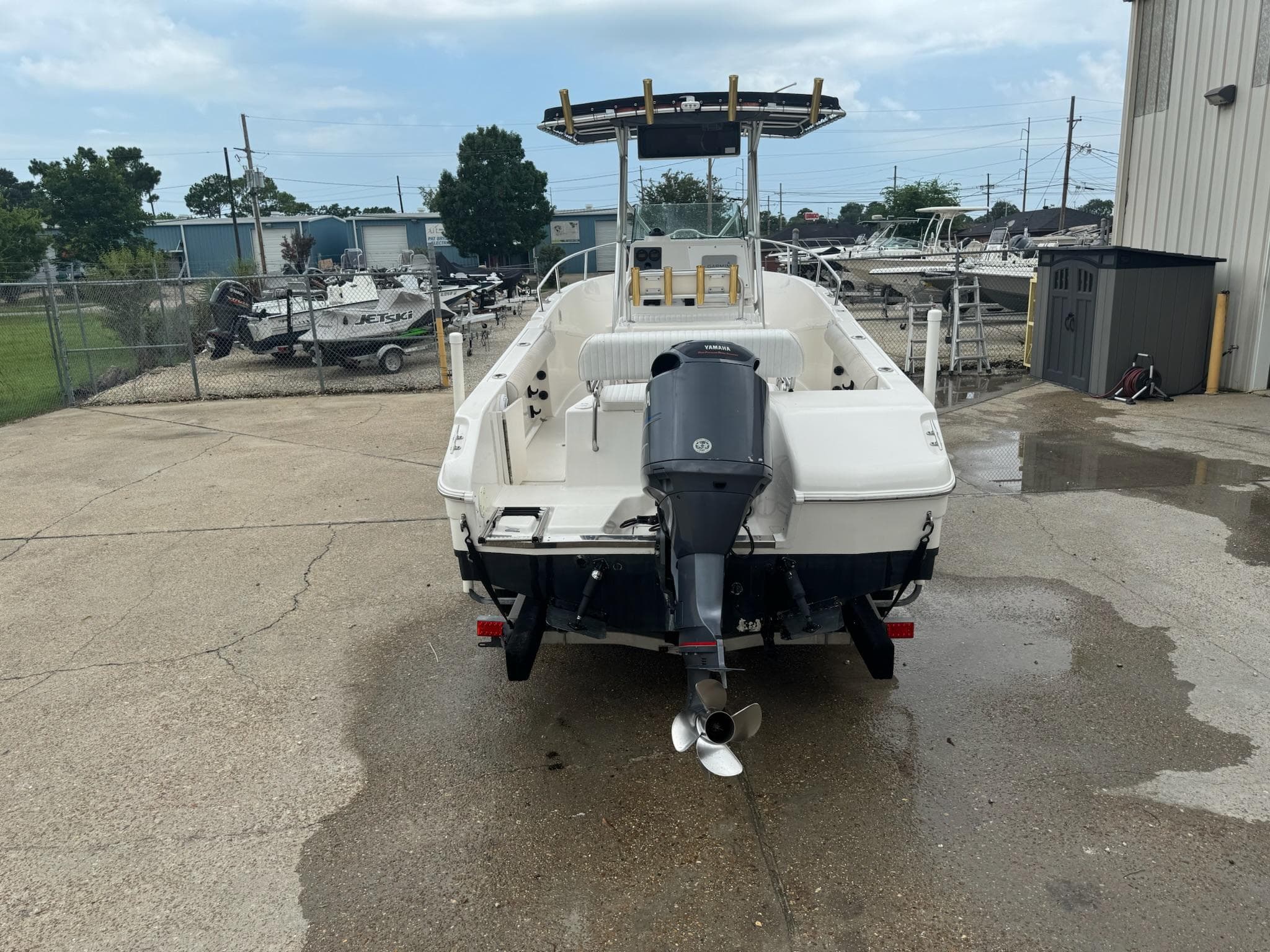 2004 Robalo R230 Center Console boat with Yamaha outboard motor, parked outdoors.