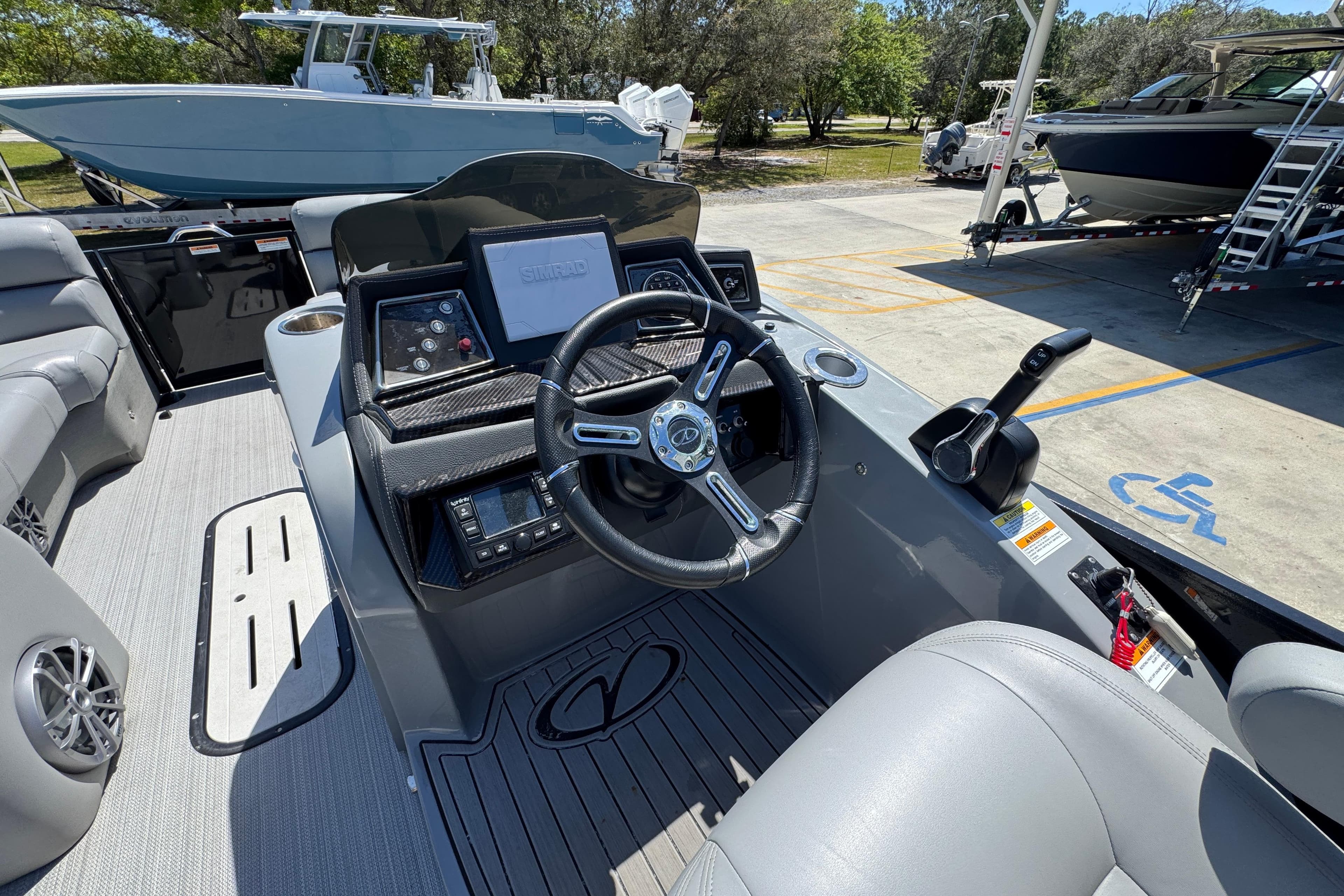 2023 Veranda VTX 25RC boat cockpit with steering wheel, control panel, and seating.