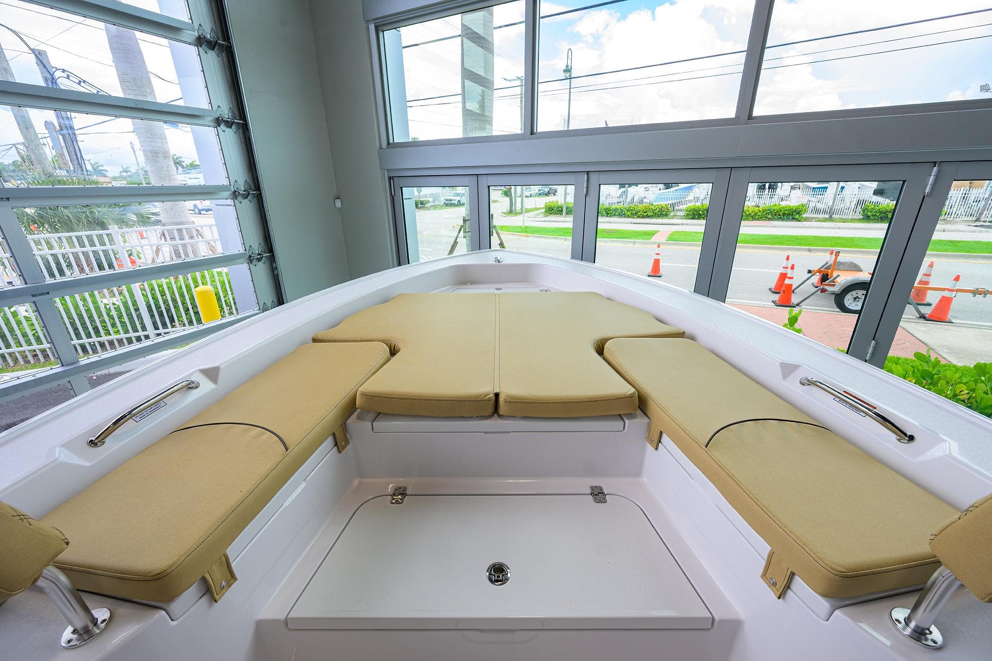 2025 Sportsman Masters 267 Bay Boat interior with beige seating, docked indoors.