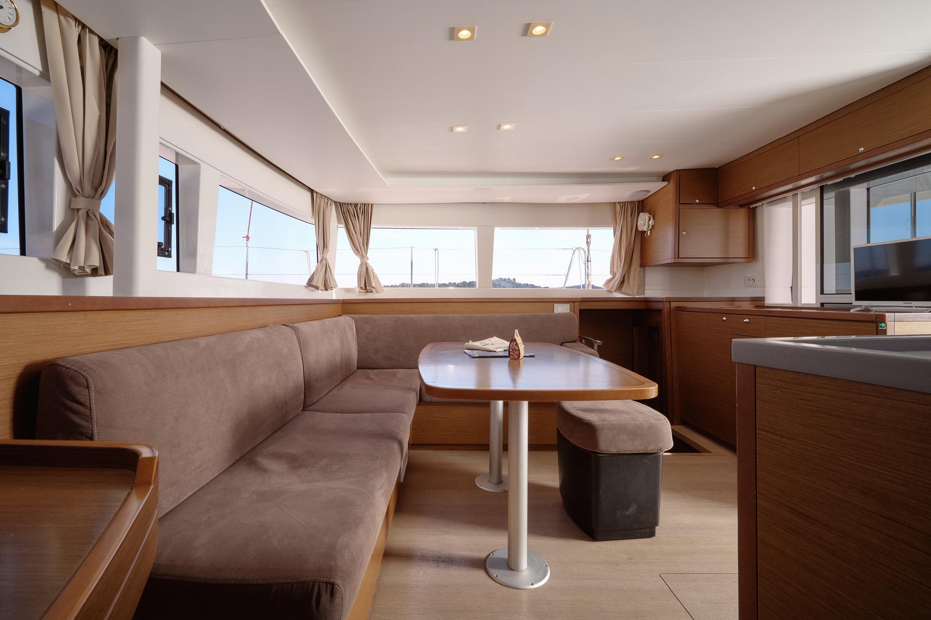 Interior of 2018 Lagoon 450 catamaran with spacious seating and modern kitchen area.