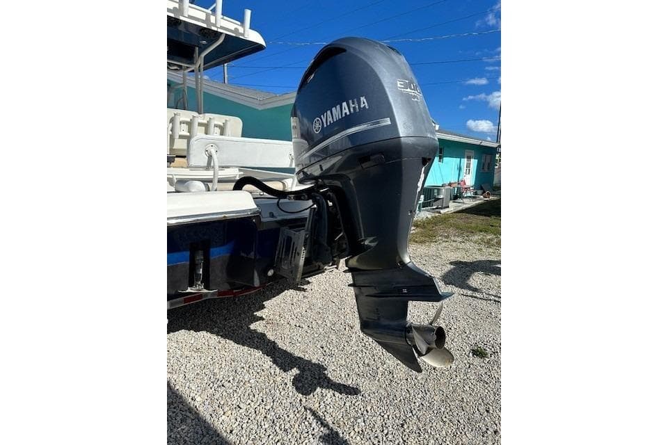 2014 ShearWater 25 LTD boat with Yamaha outboard motor, parked on gravel.