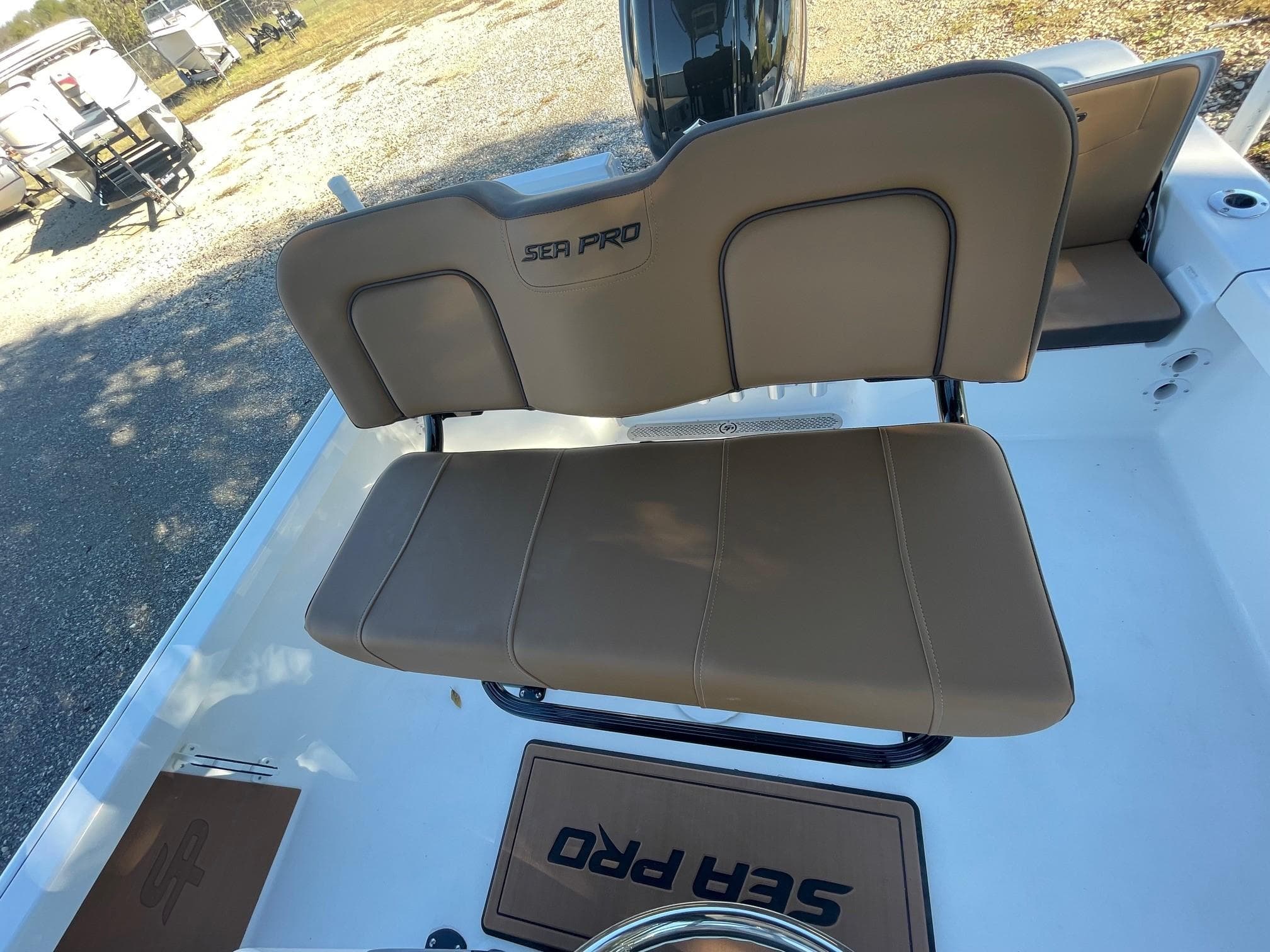 2025 Sea Pro 210 DLX boat with tan seating and logo.