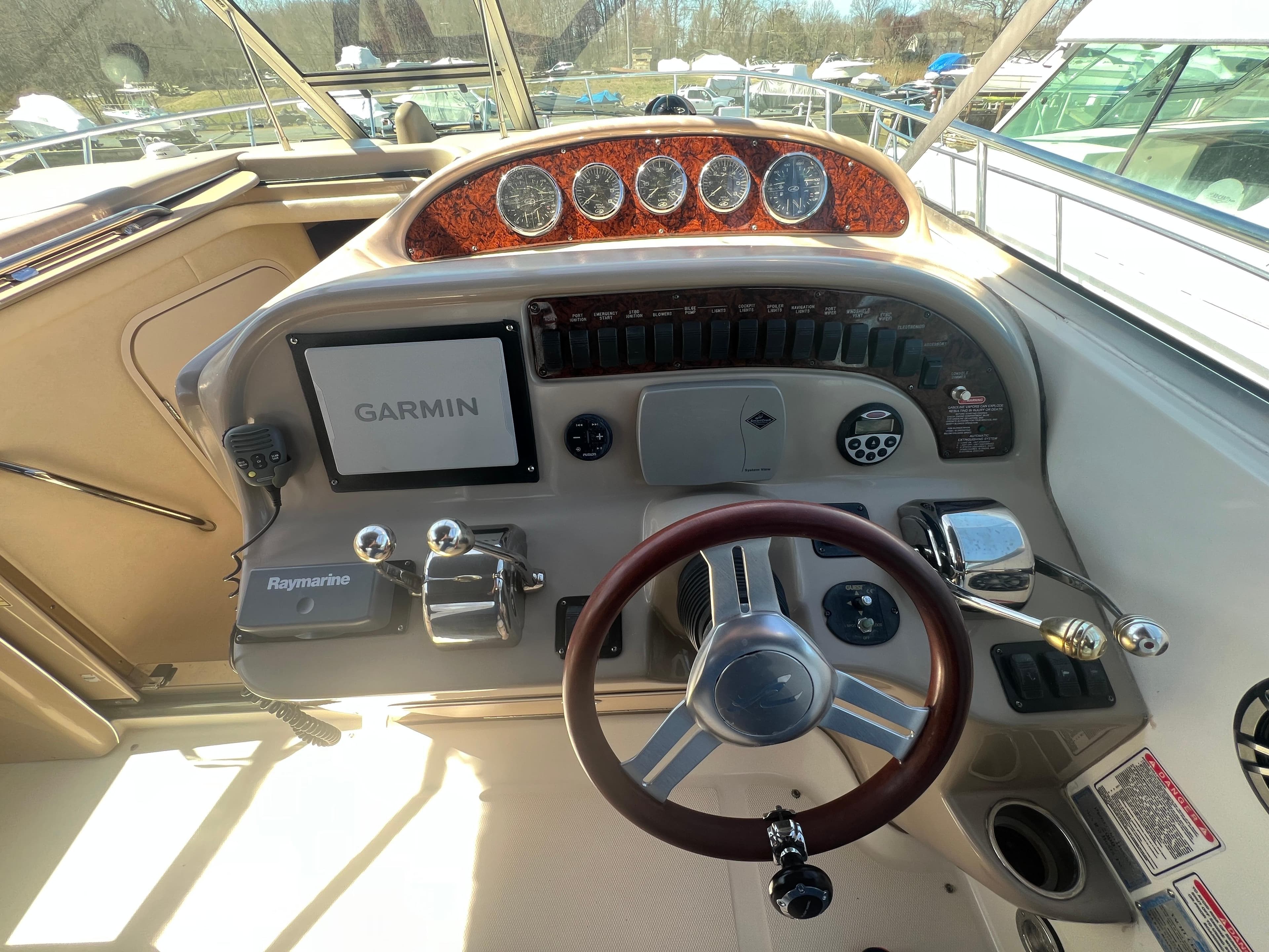 2005 Sea Ray 290 Amberjack helm with Garmin navigation and Raymarine controls.