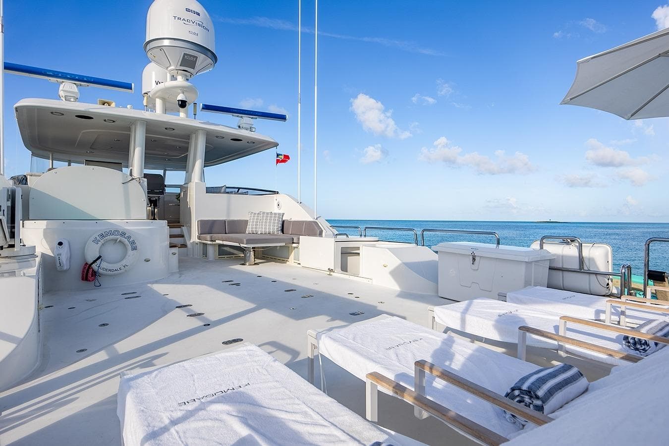 Luxurious 2007 Westport 112 yacht deck with sun loungers and ocean view.
