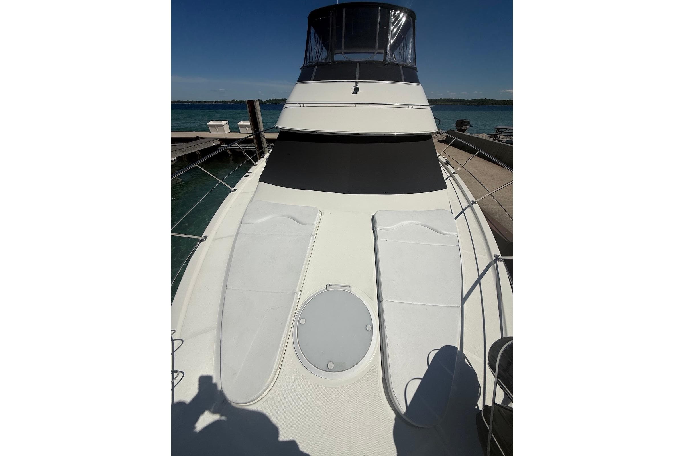 2004 Carver 396 Motor Yacht docked, showcasing spacious deck and sleek design.