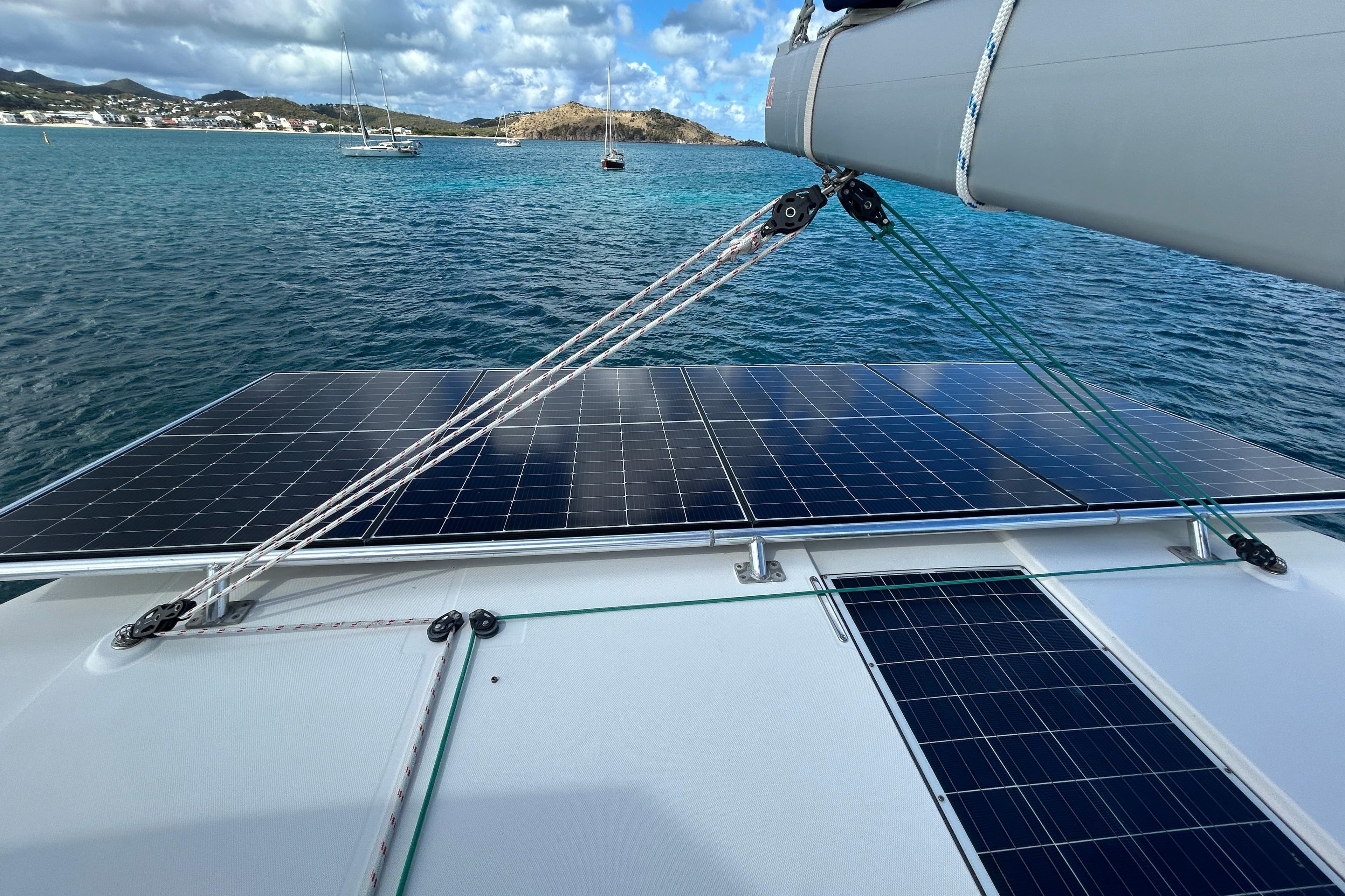 Leopard 45 catamaran with solar panels on deck, sailing in clear blue waters, 2020 model.