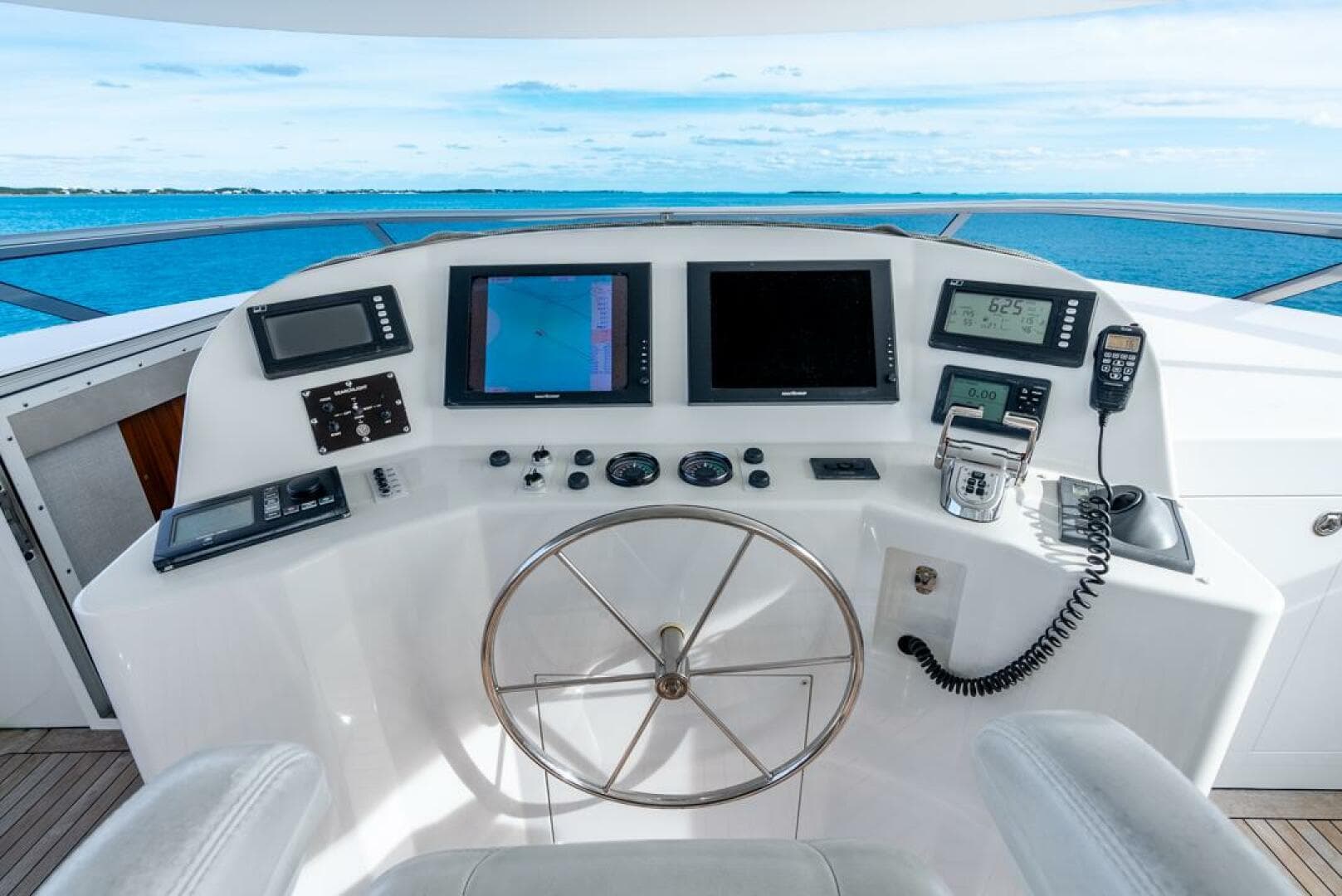 Helm of 2012 Westport 112 yacht with navigation screens and controls.