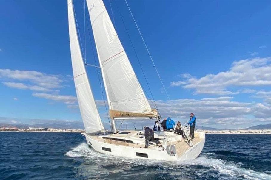 Sailing yacht Solaris 40, 2021 model, cruising on open sea under clear blue skies.