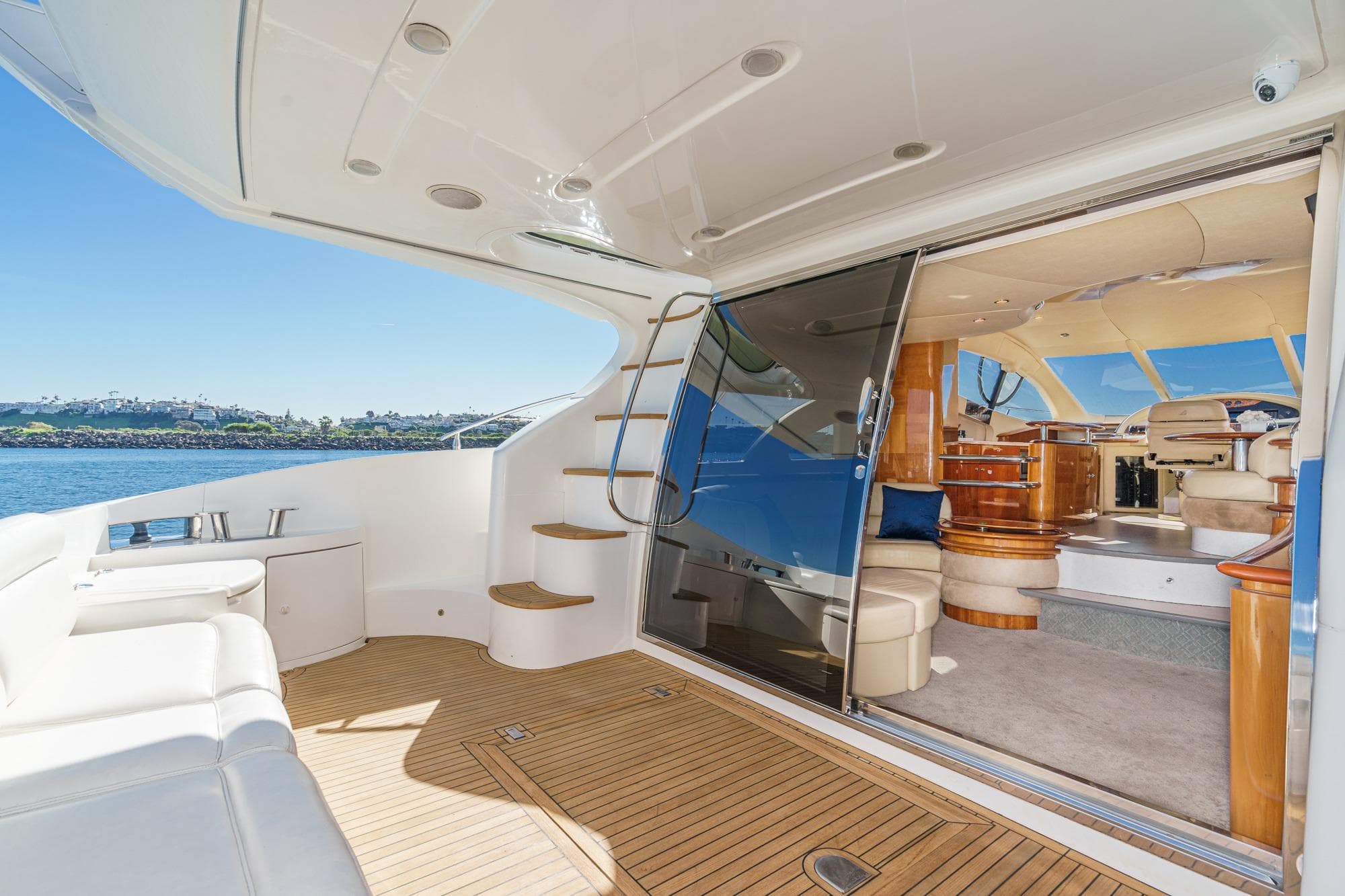 Luxurious 2002 Azimut 58 yacht interior with elegant seating and scenic ocean view.
