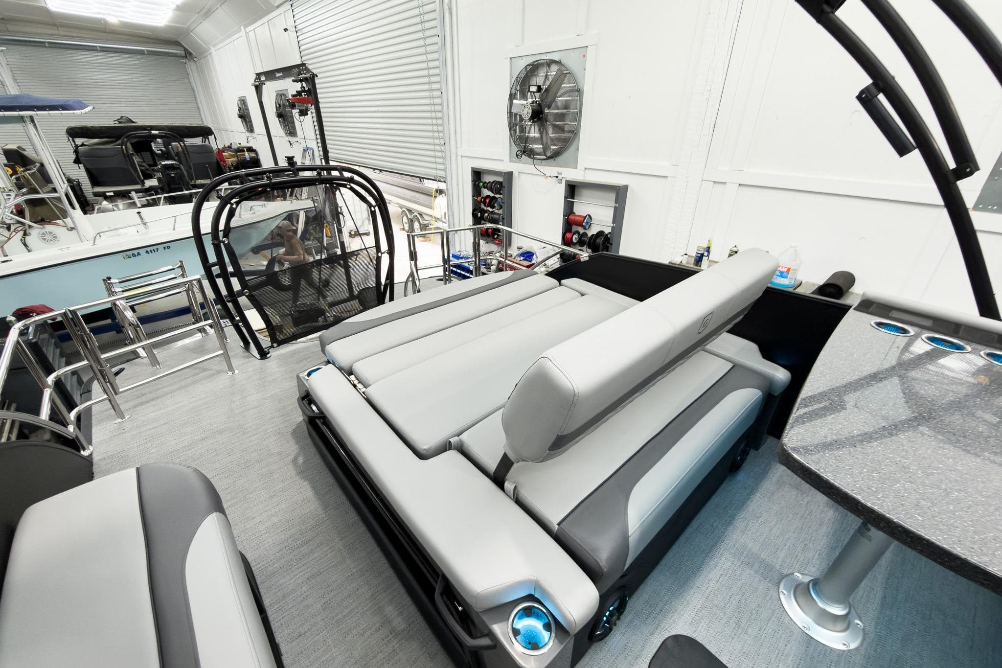 Luxurious interior of 2026 Godfrey Monaco 25' Tritoon with flip lounge seating.