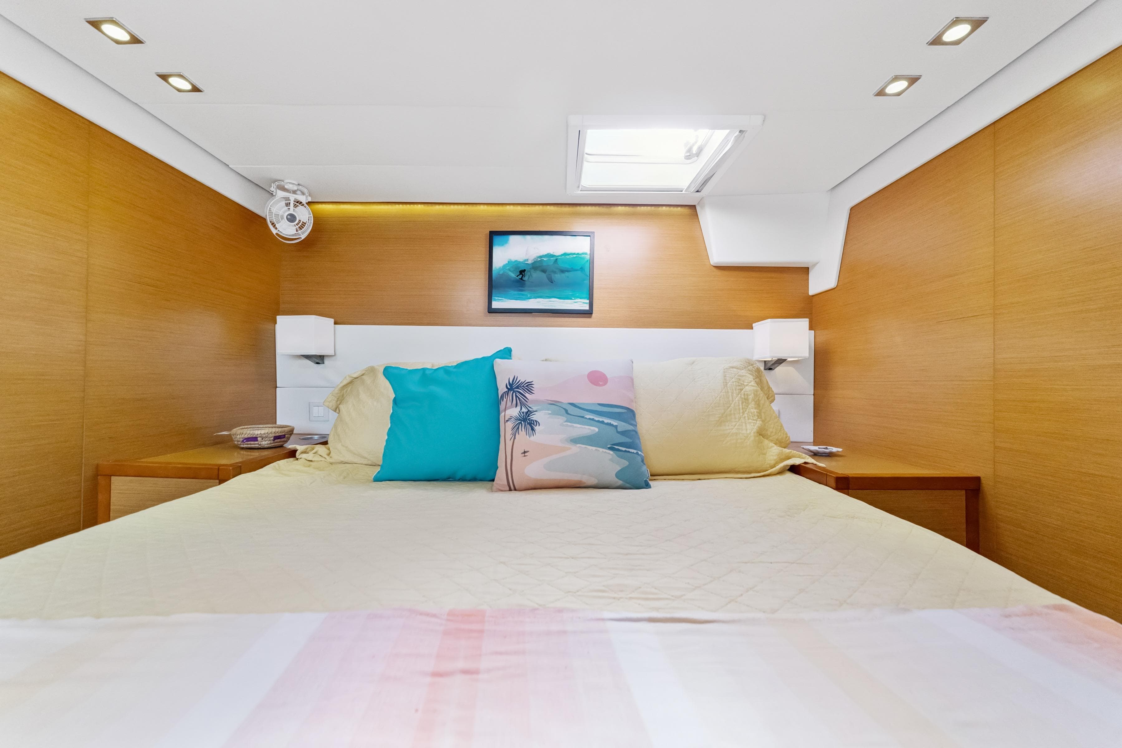 Luxurious bedroom interior of 2012 Lagoon 560 yacht with modern decor and skylight.
