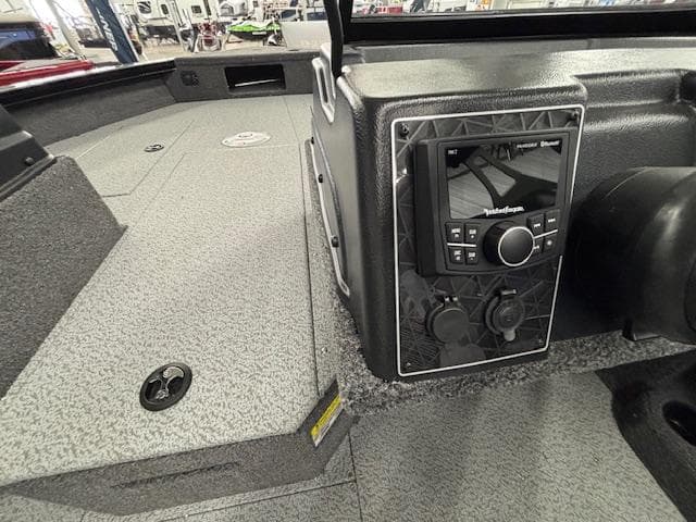 2025 Crestliner 2050 Fish Hawk boat interior with control panel and textured flooring.