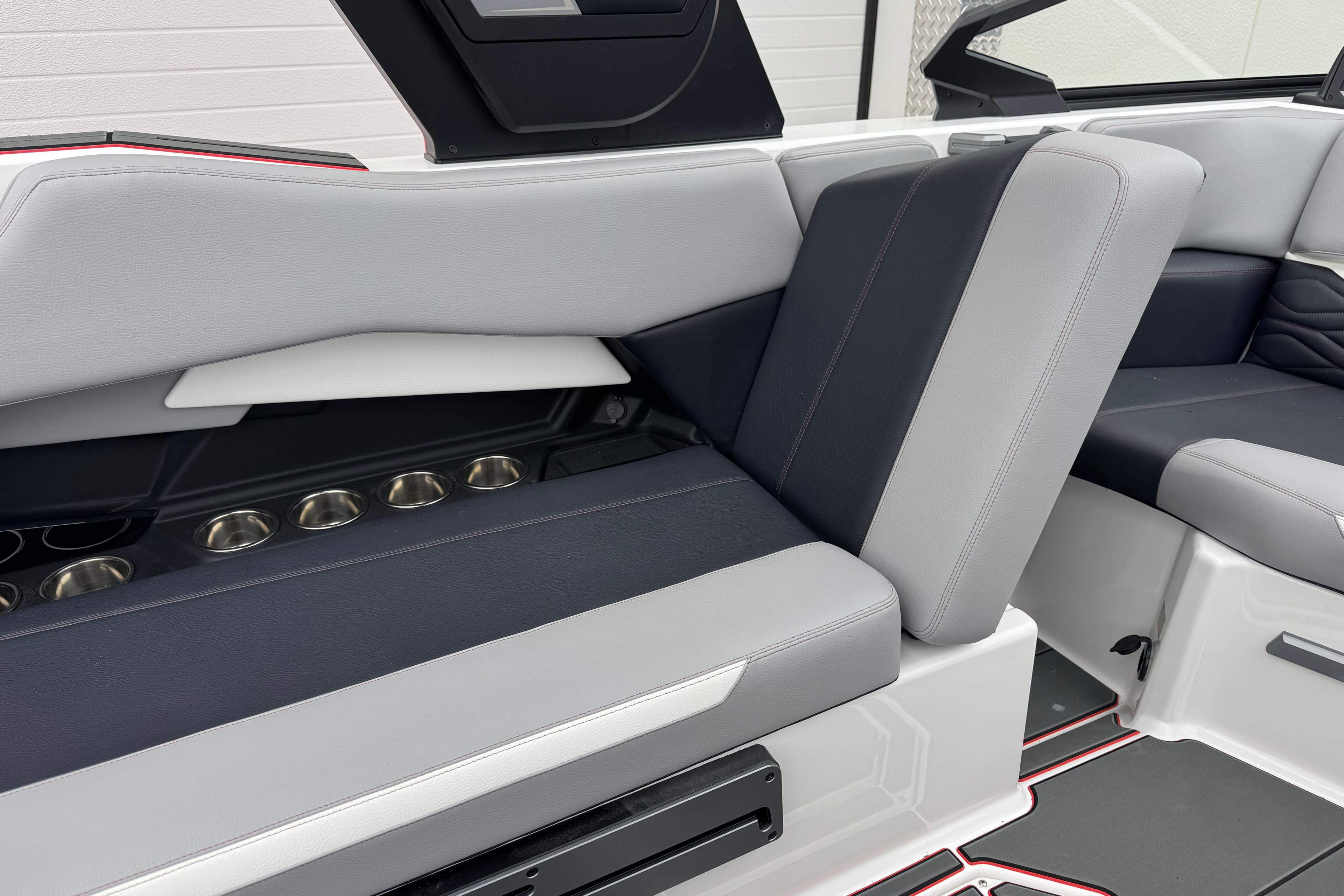 Interior of 2025 Supra SE 575 boat with sleek seating and cup holders.