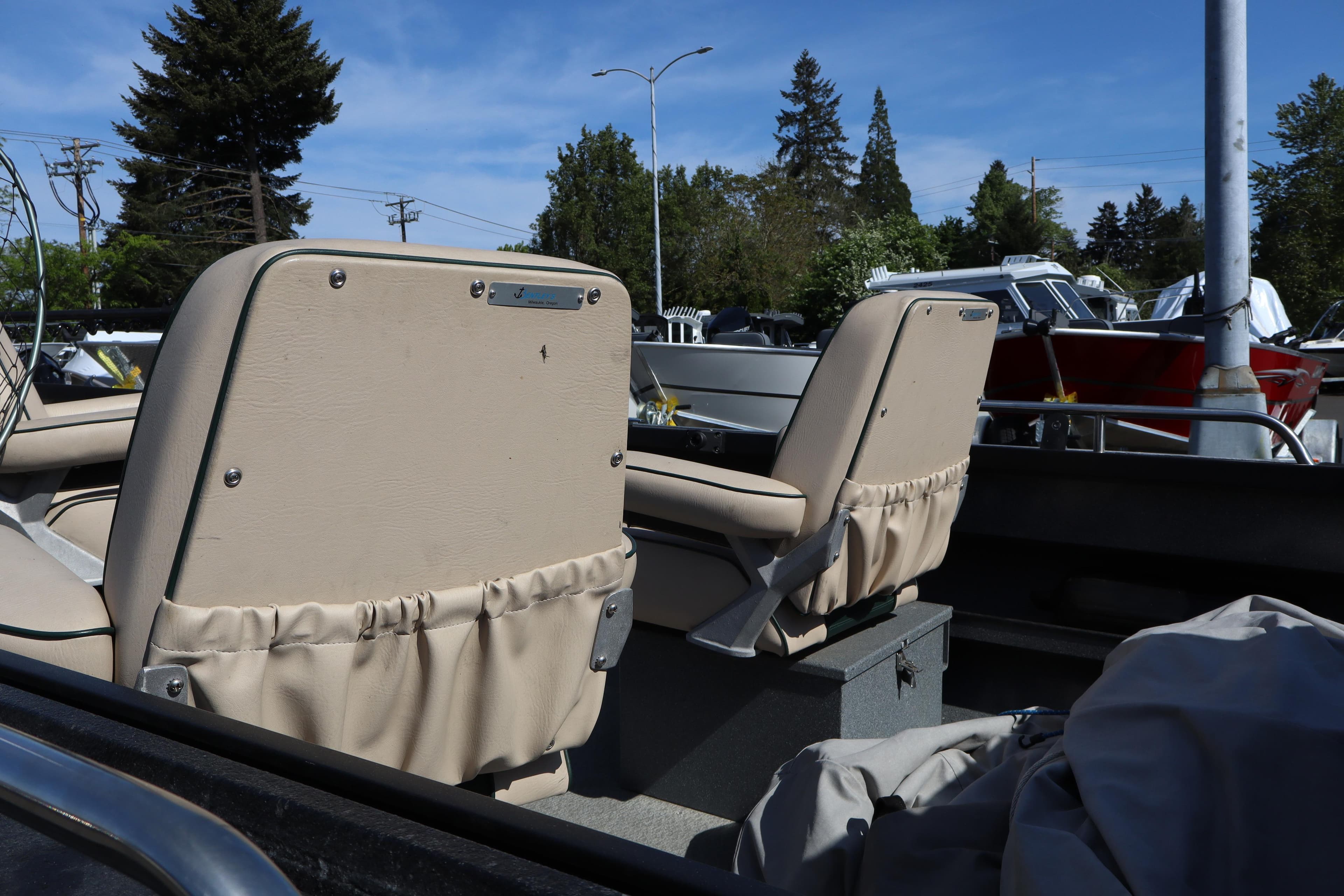 1997 Willie Boats Predator with beige seats, parked outdoors under clear blue sky.