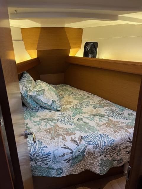 2019 Jeanneau Sun Odyssey 389 cabin with nautical-themed bedding.