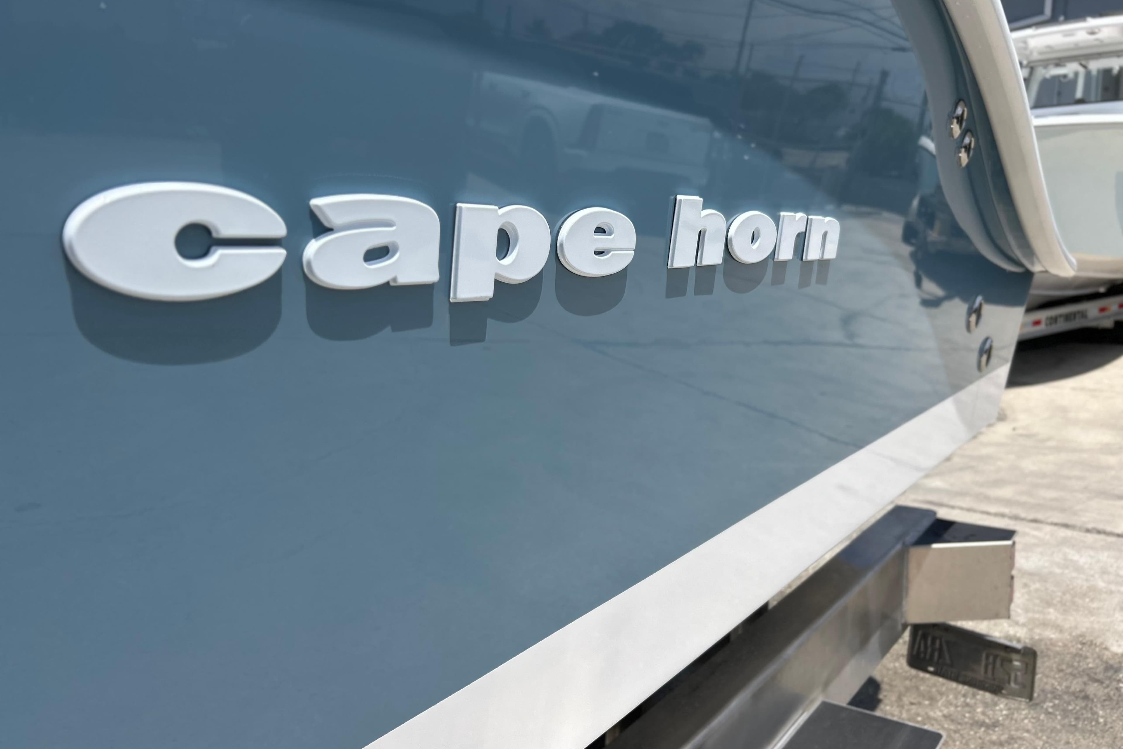 2025 Cape Horn 34 XS boat, close-up of logo on sleek blue hull.