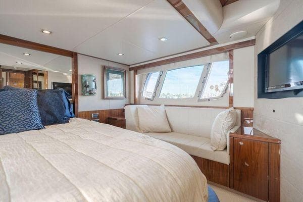 Luxurious Sunseeker Manhattan 60 yacht bedroom interior, 2010 model, featuring elegant wood finishes.