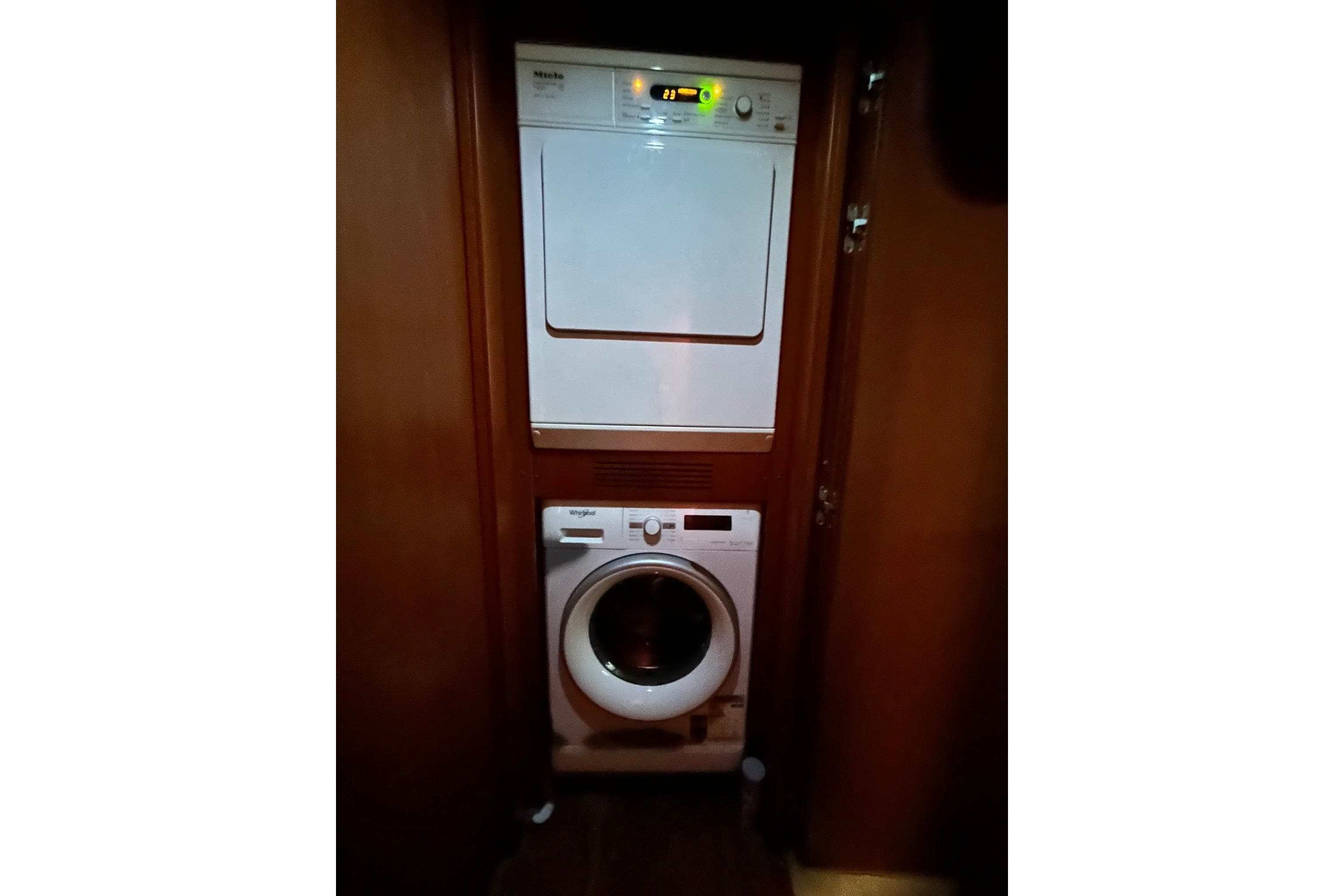 Laundry area with washer and dryer on Versilcraft Euroyacht Planet 125S Hardtop, 2010 model.