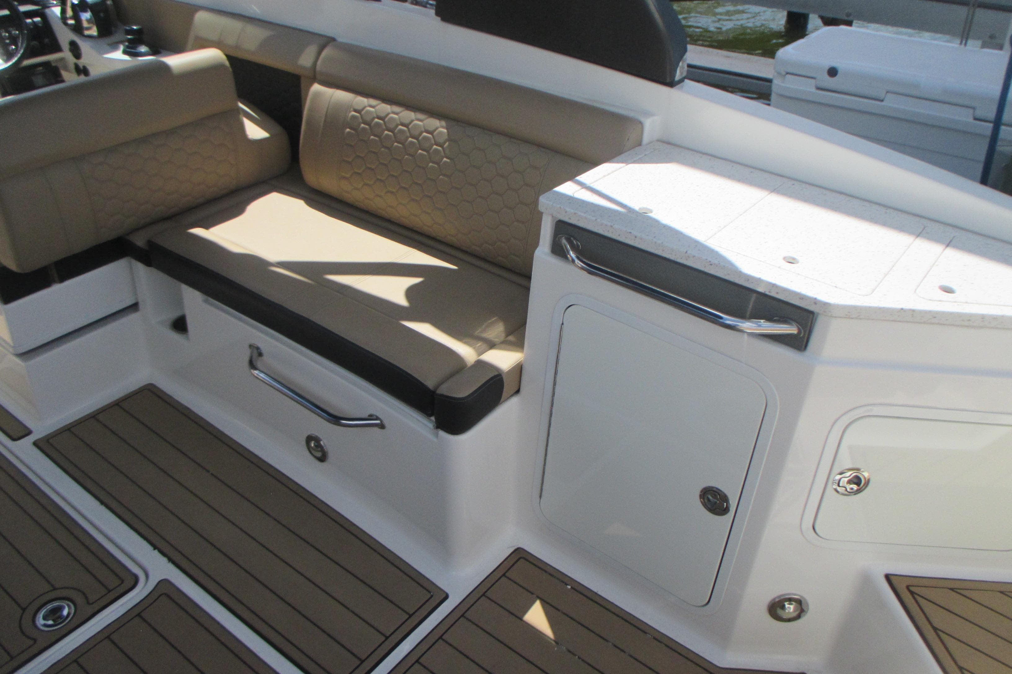 2019 Sea Ray 290 SLX interior with beige seating and white cabinetry.