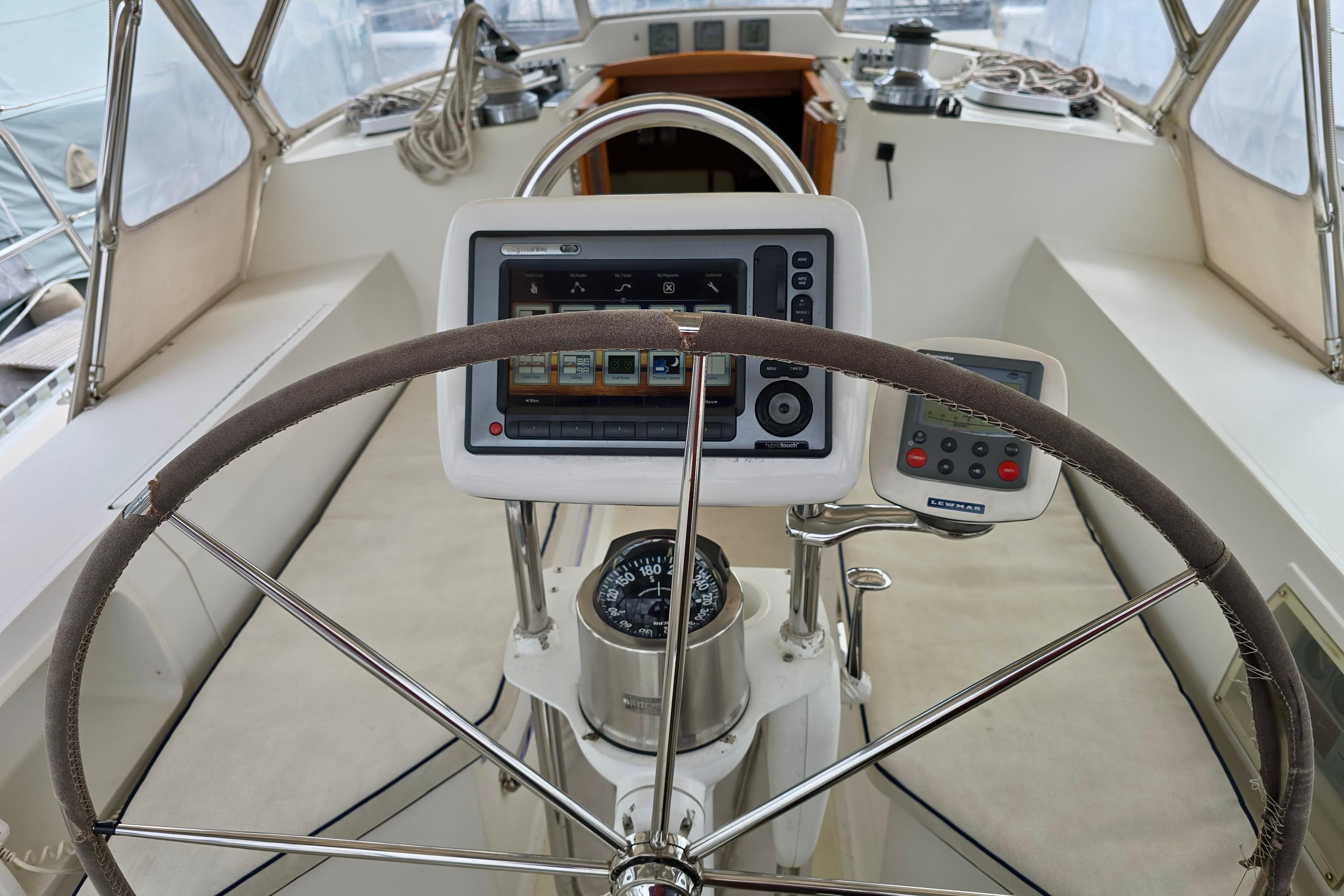 Steering wheel and navigation equipment on a 2006 Outbound 44 sailboat.