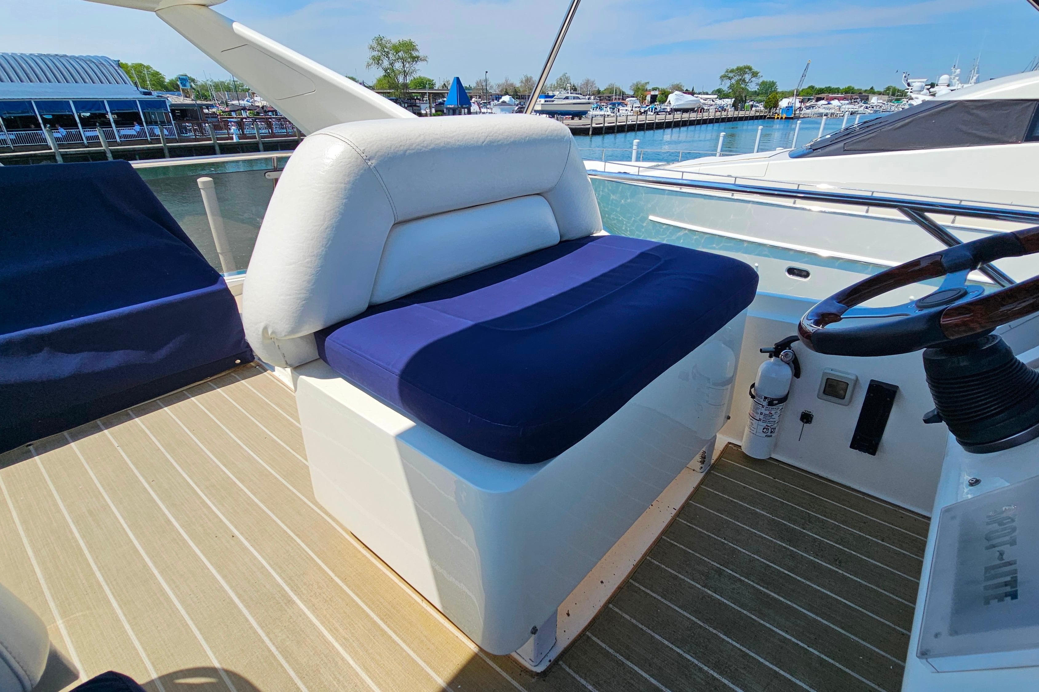 Captain's seat on 1998 Sunseeker Manhattan 62 yacht, overlooking marina.