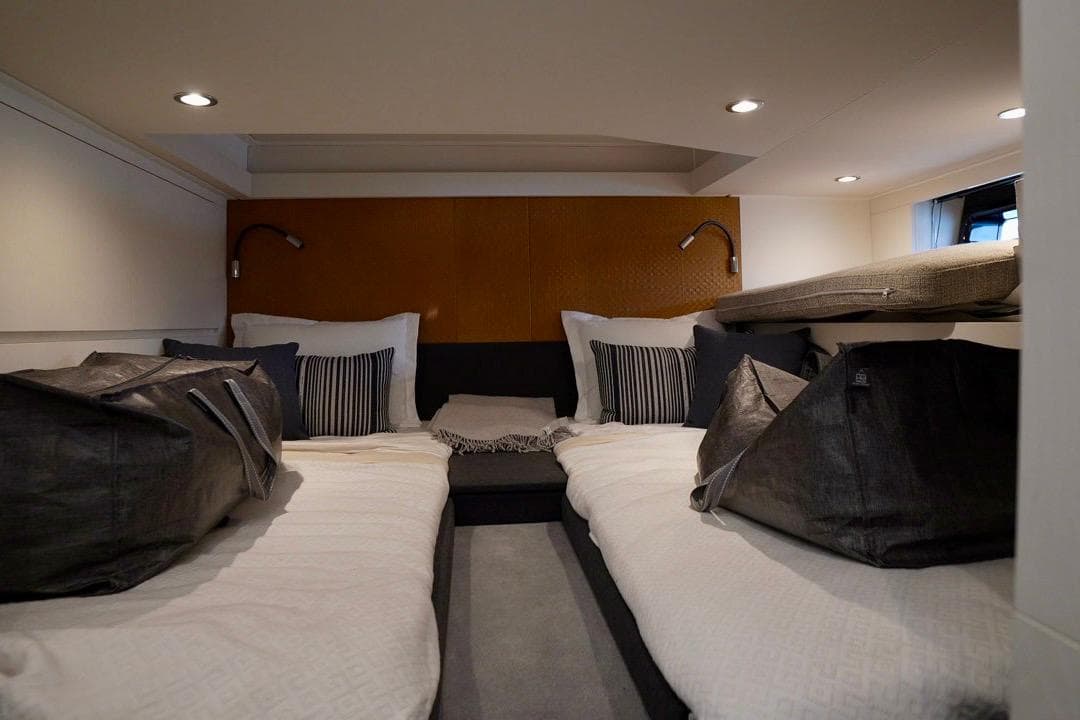 Luxurious interior cabin of 2024 Azimut Verve 48 yacht with modern bedding and lighting.