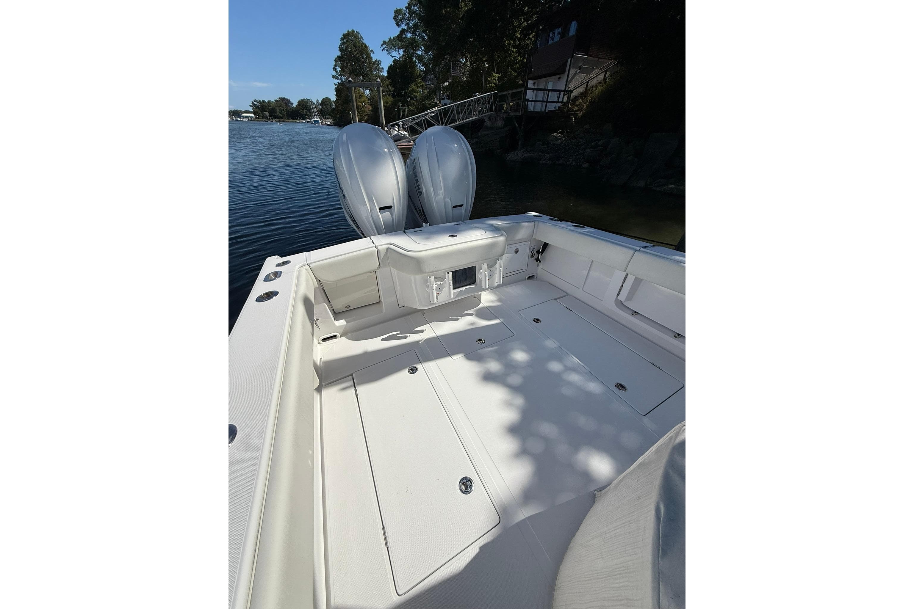 2021 Jupiter 38 HFS boat with dual outboard motors on a sunny day.