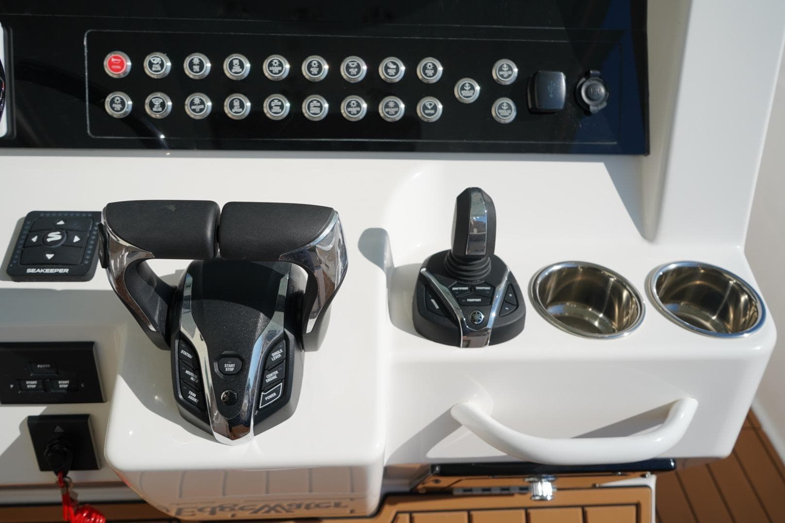 2024 Edgewater 285CC boat console with controls and cup holders.