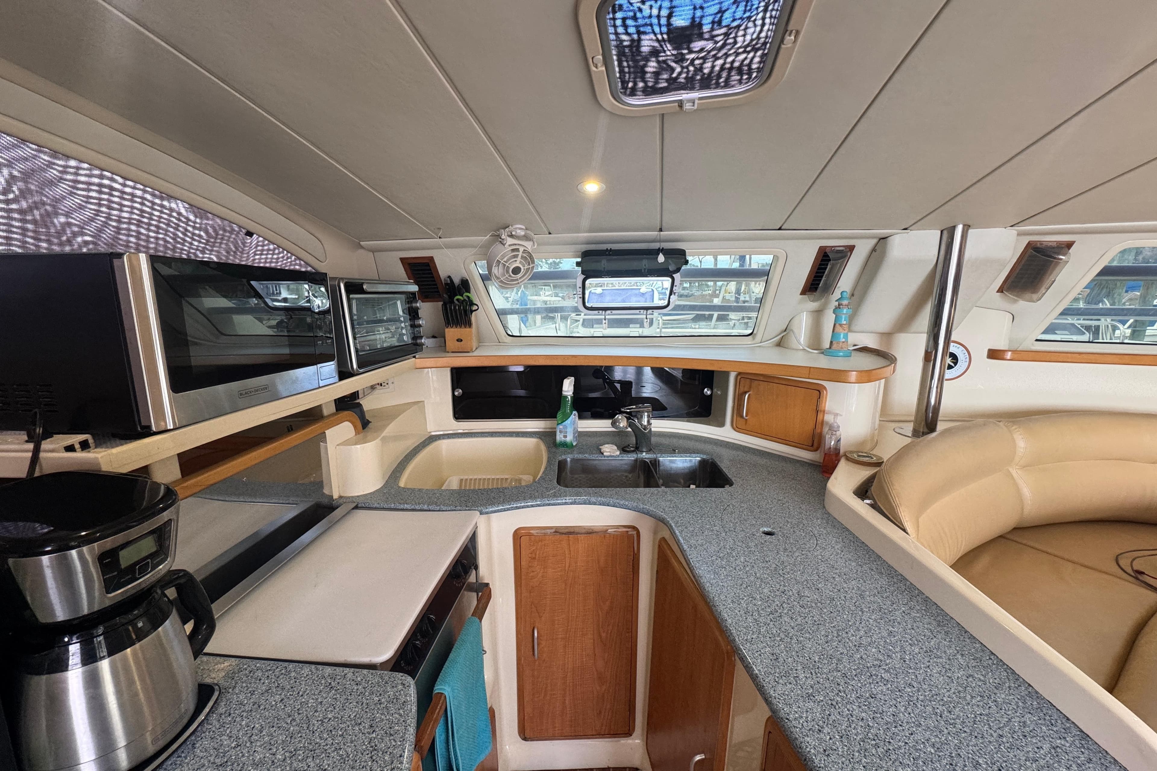 Interior of 2002 Leopard 42 yacht kitchen with modern appliances and seating area.
