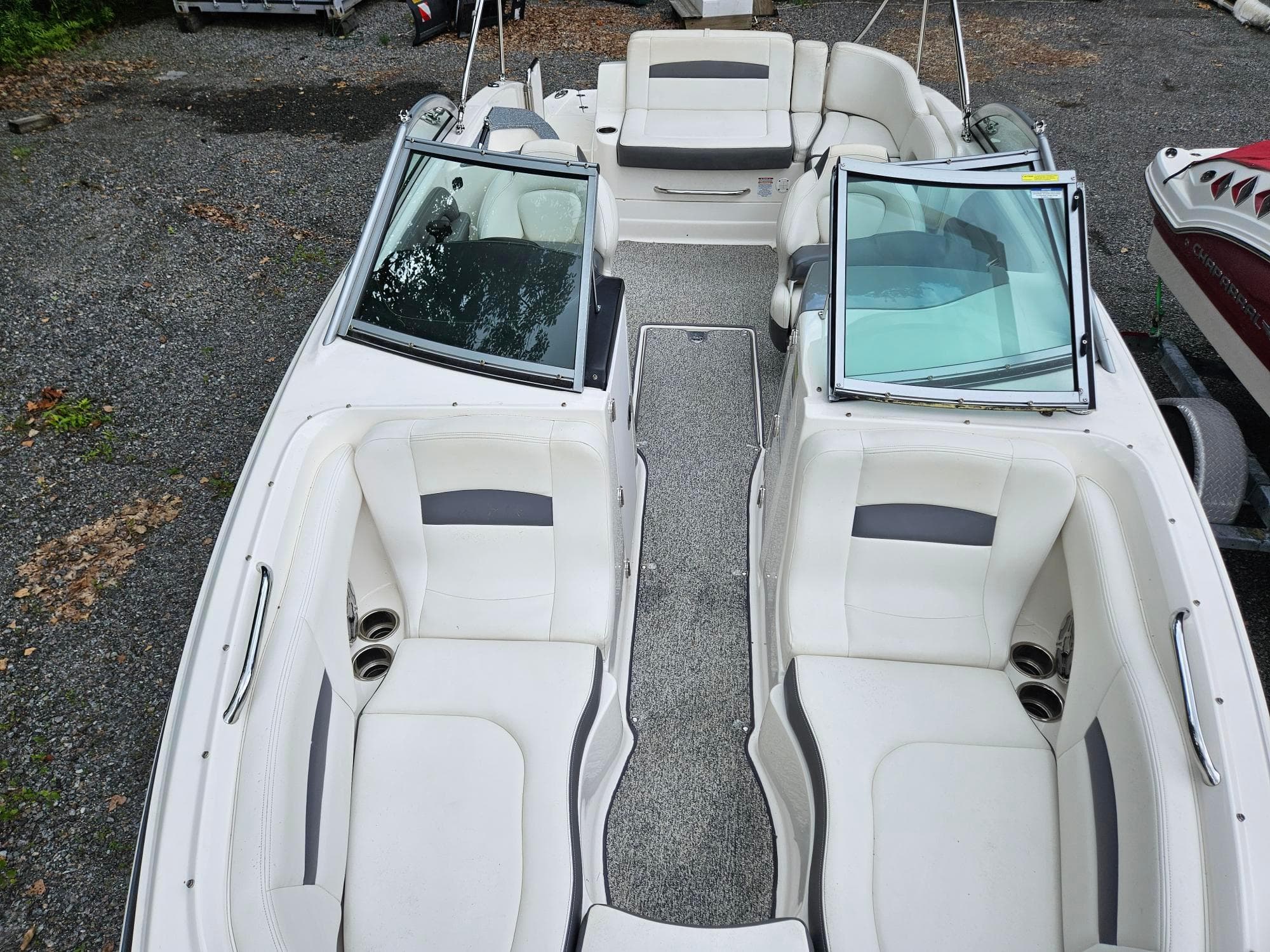 2014 Chaparral 224 Sunesta boat interior with white seating and open windshield.