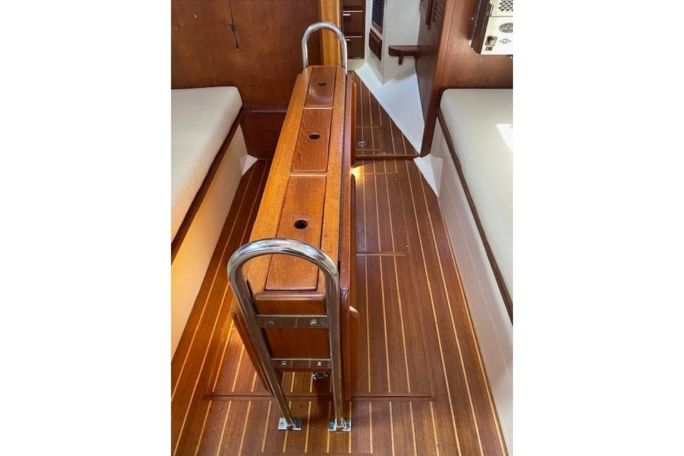 Interior of 1995 Pacific Seacraft Crealock 34 sailboat with wooden flooring and ladder.