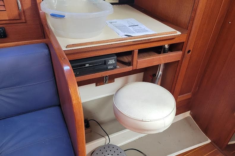 Interior of 1988 Freedom 36 yacht with seating, table, and storage.